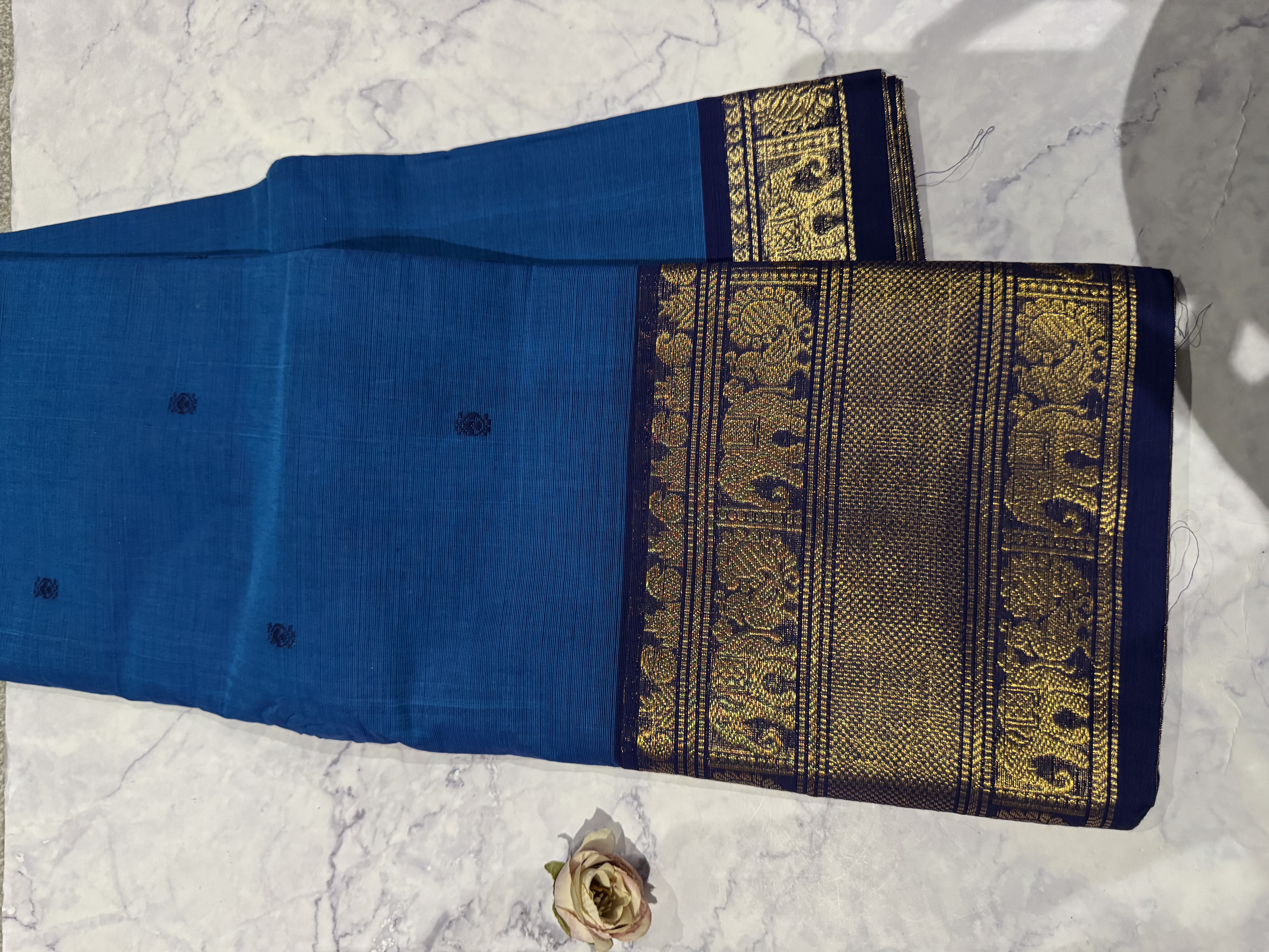 Bright blue cotton saree with navy blue border