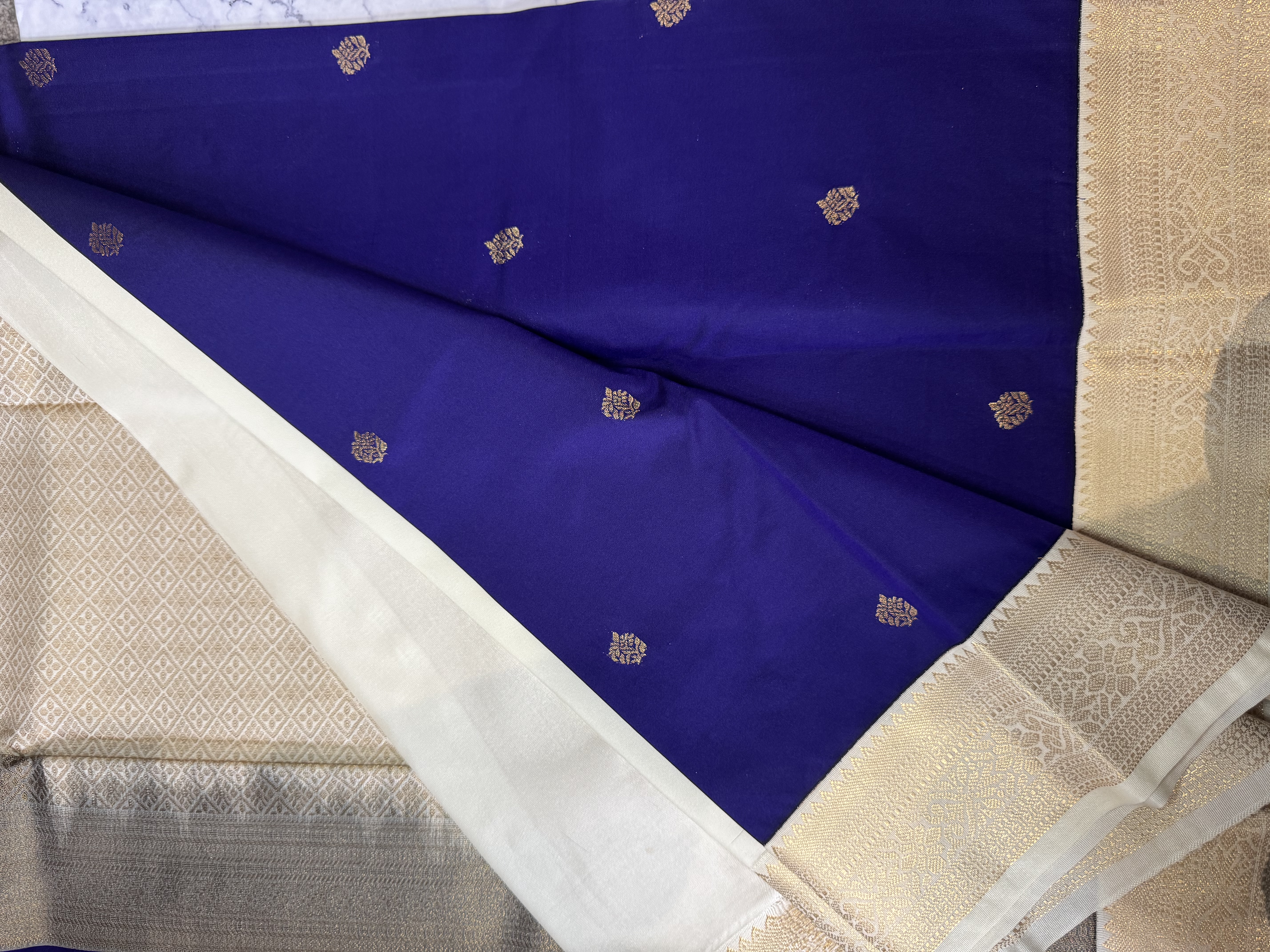 Navy blue semi silk saree with cream blouse