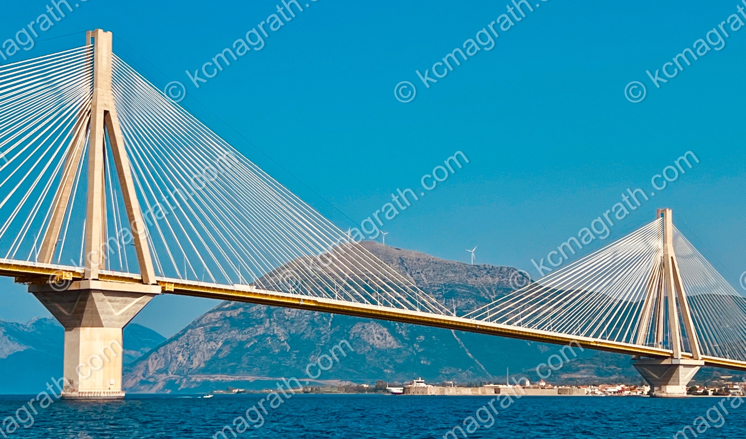 Rio- Antirrio Bridge Charilaos Trikoupis 3 with Wind Turbines on Mountain, Photographed from our Sailboat, Greece
