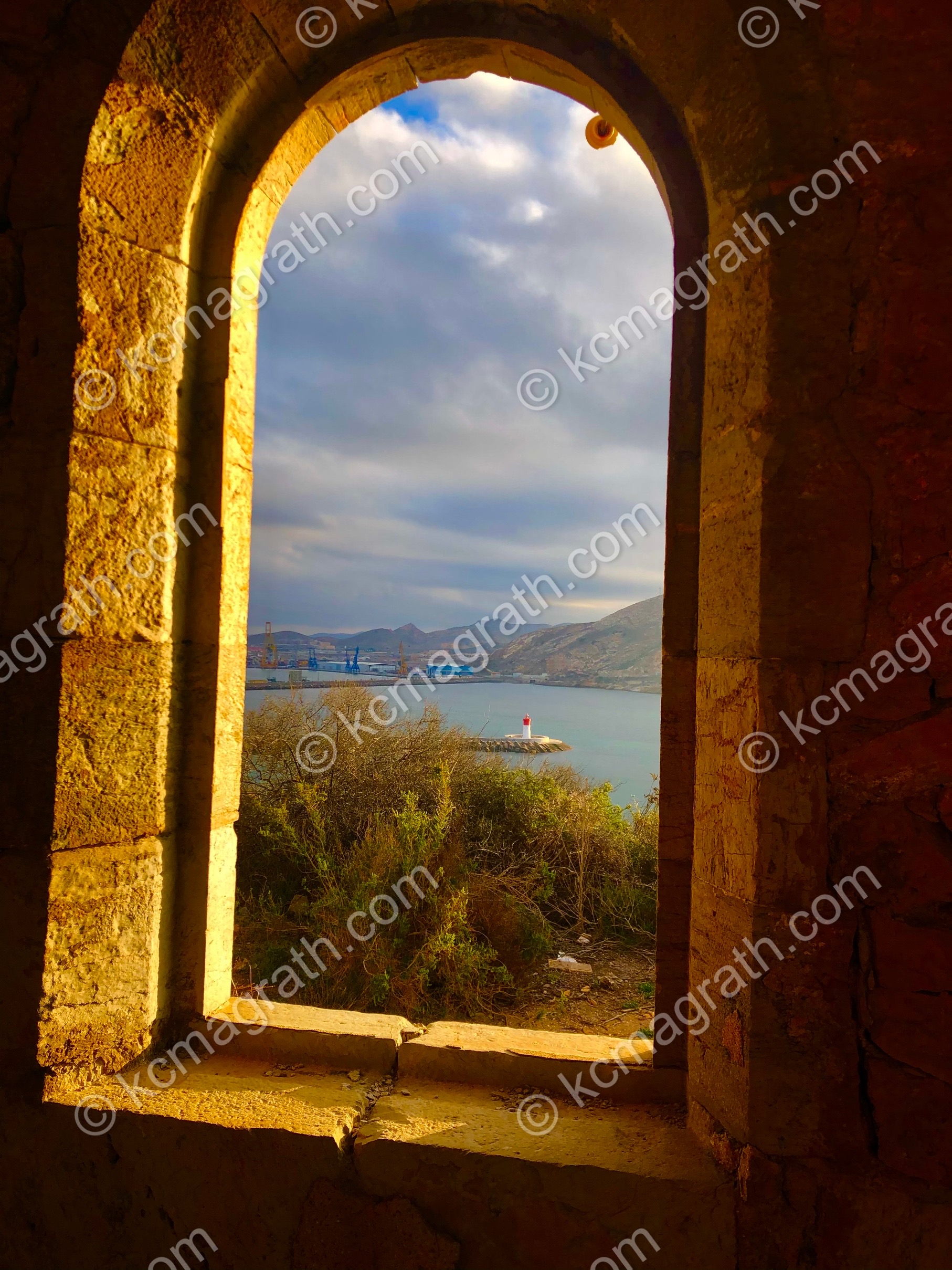 Cartagena's Faro y Mirador de La Podadera Ruins with Golden Sunlight, Lighthouse Seen Through Window, Spain