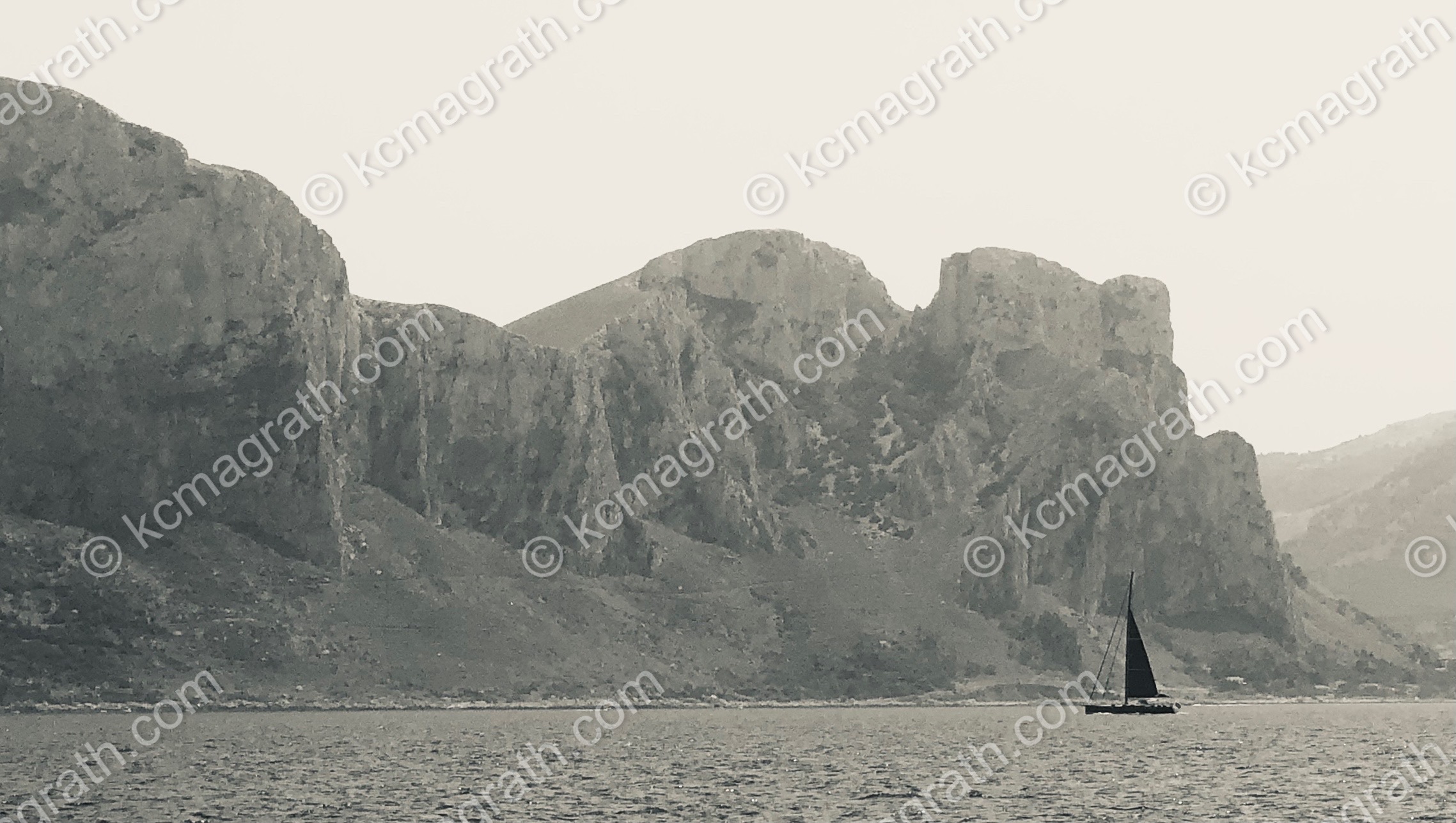 Siciliy's Cliffs with Black Sailboat Silhouette, B&W, Italy
