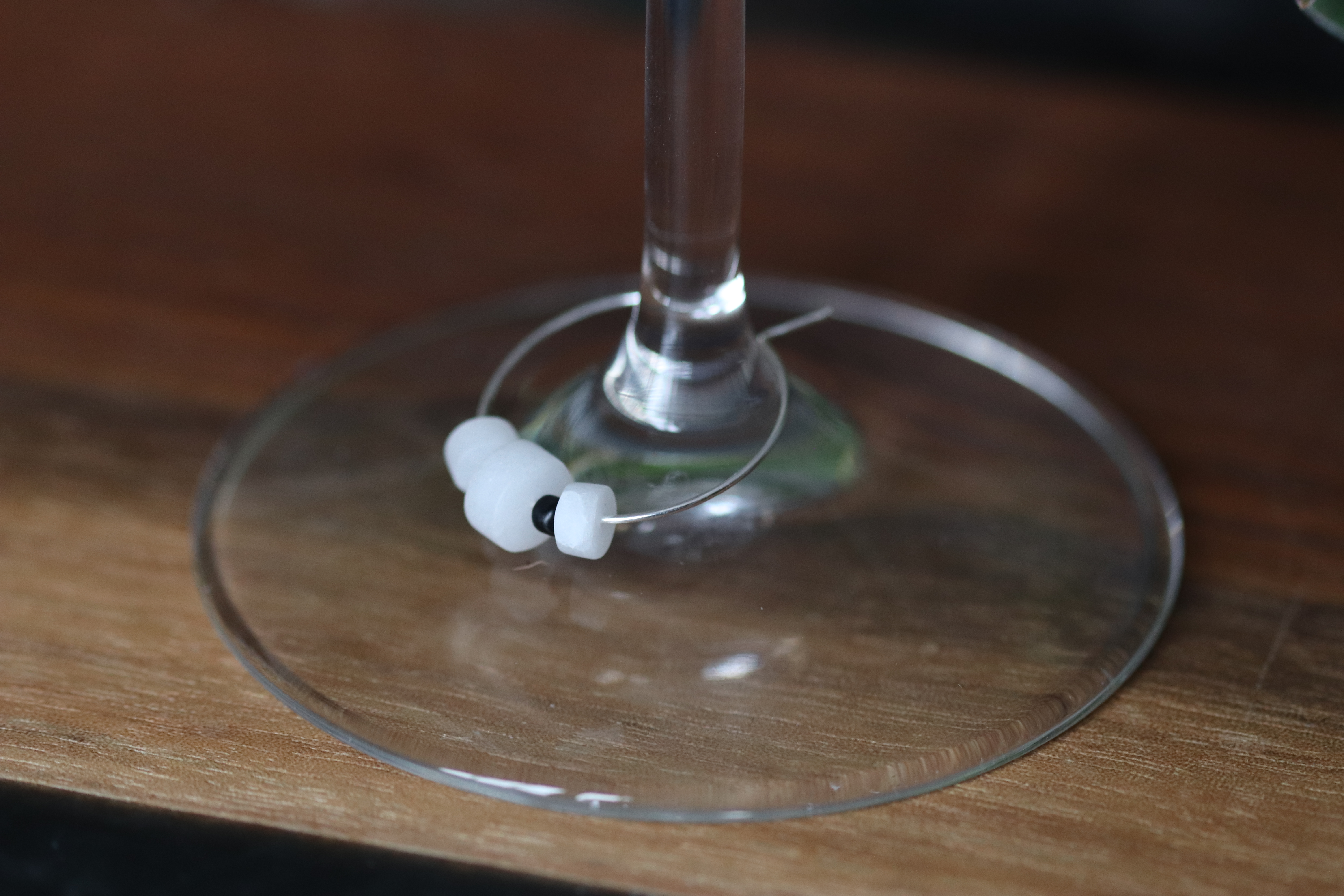Unique White Quartz Wine Charm called "Something's in the snow"