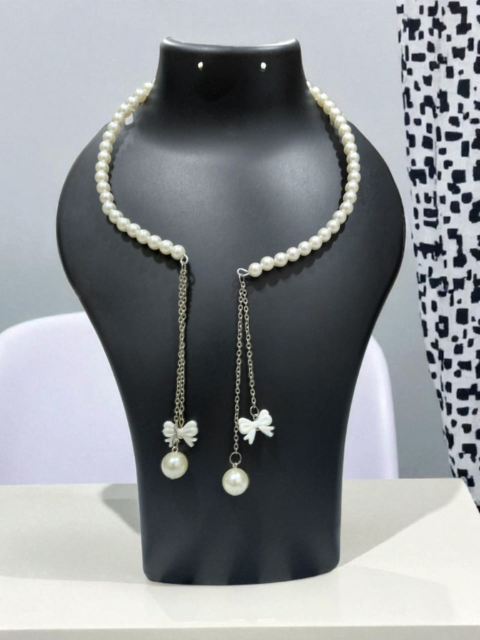 Elegant Pearl Necklace with Bow Charms