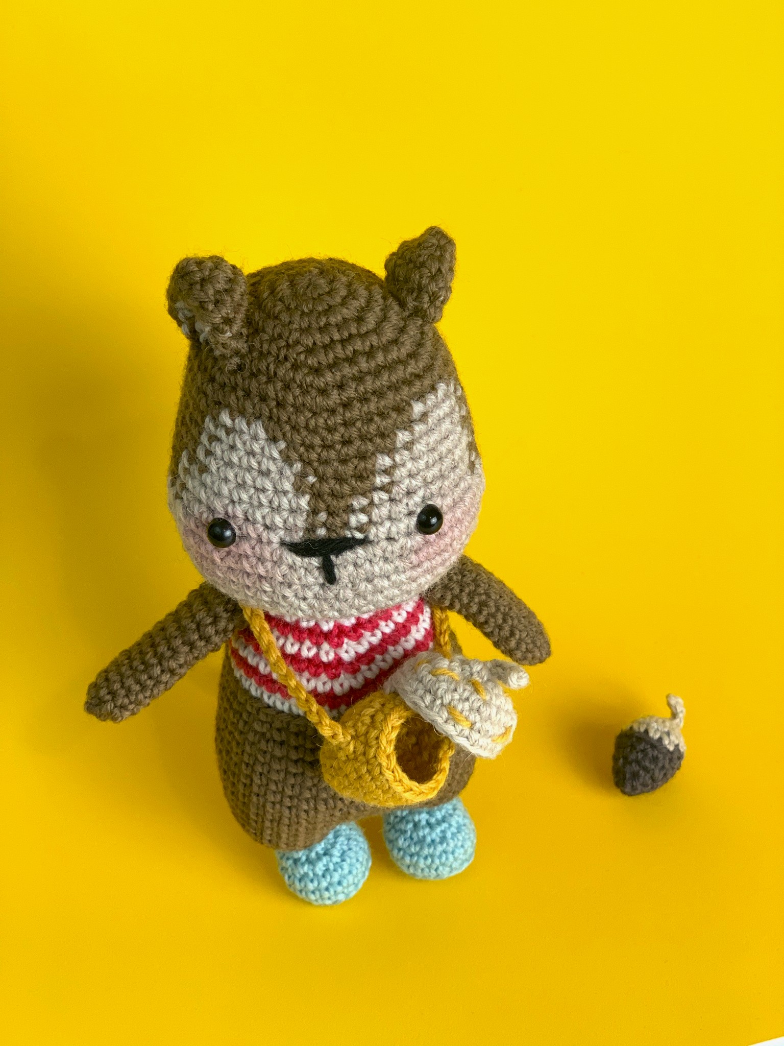 Handmade Crochet Squirrel Toy with a nut sling bag and its acorn in 100% Merino Wool