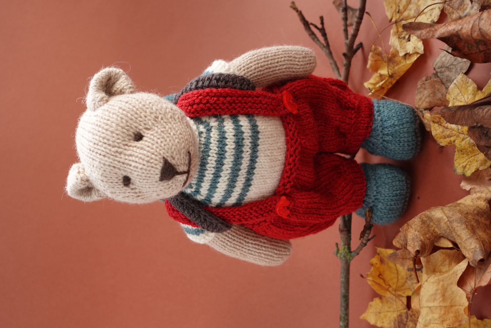 Hand-Knitted Teddy Bear in red overalls and a backpack in 100% Alpaca and Merino Wool