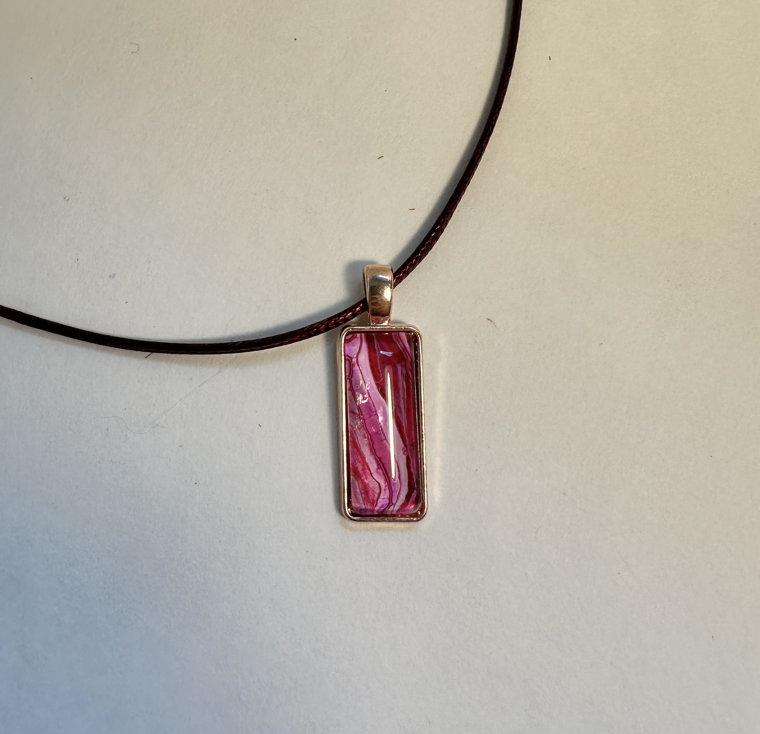 Rectangular Pink Pendant Necklace made with acrylic pouring in bezel with cabochon.