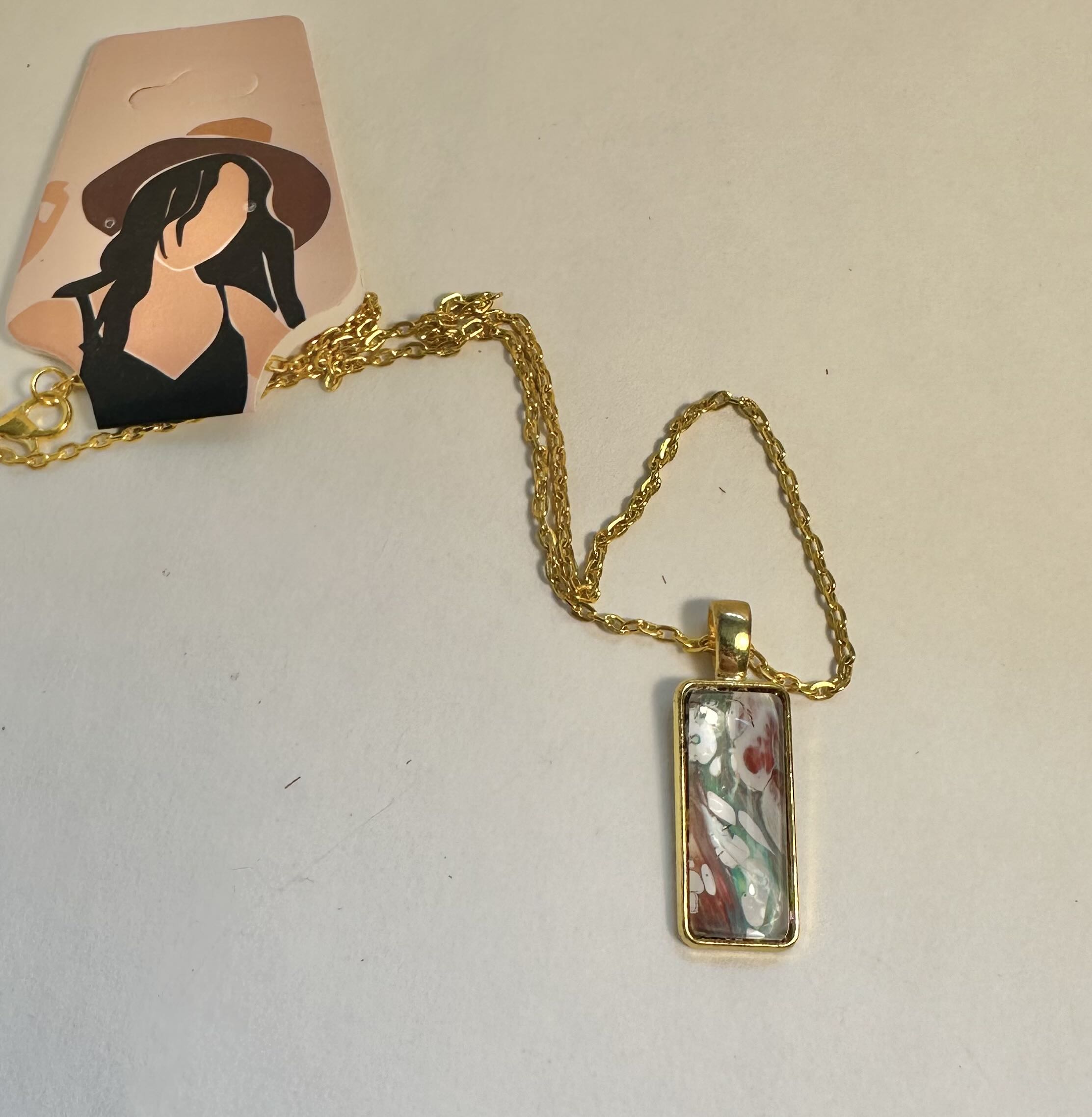 Rectangular Pendant Necklace made with a artistic paper in a bezel with cabochon.