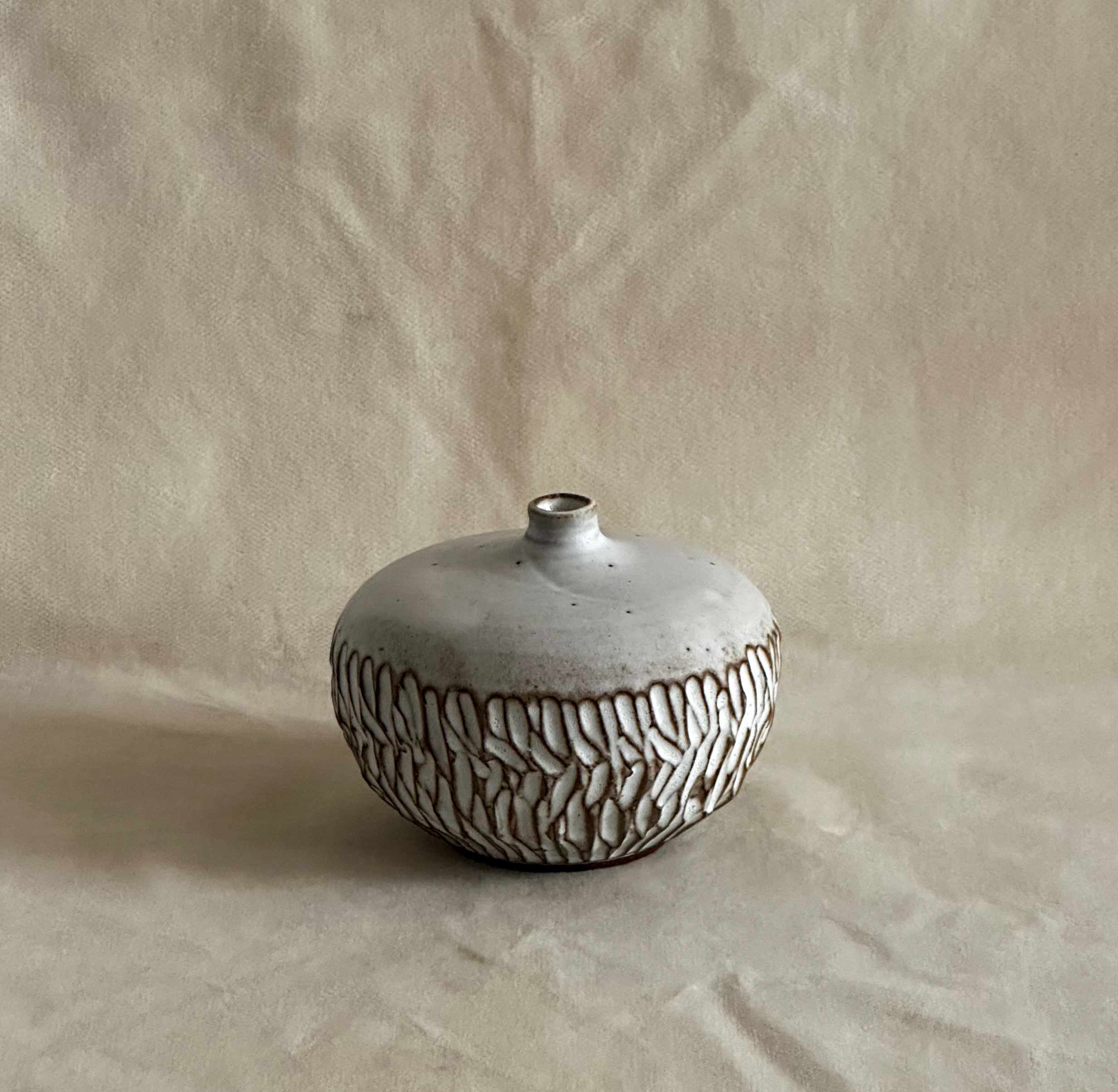 Small carved vase in white