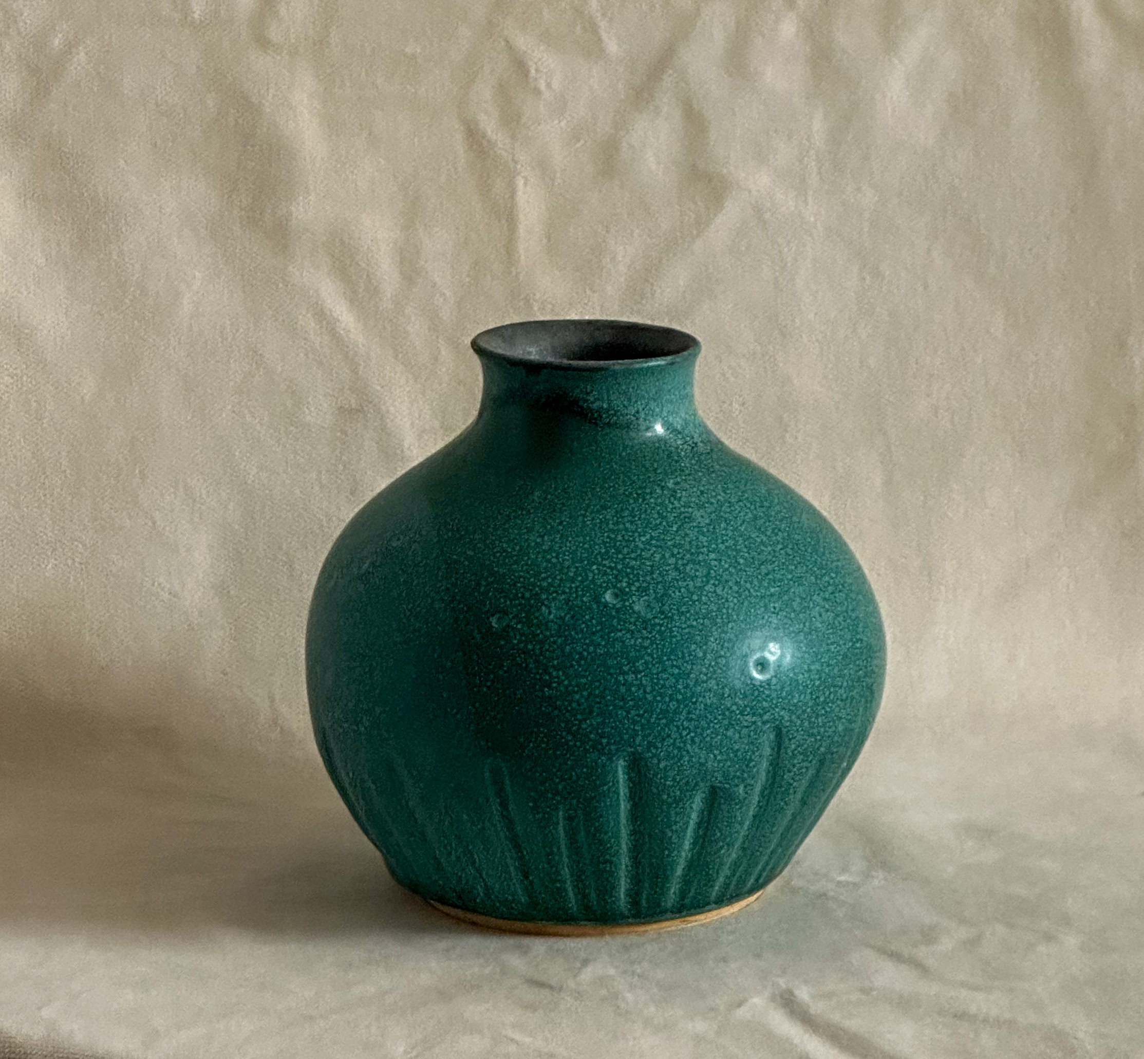 Carved vase in matte green