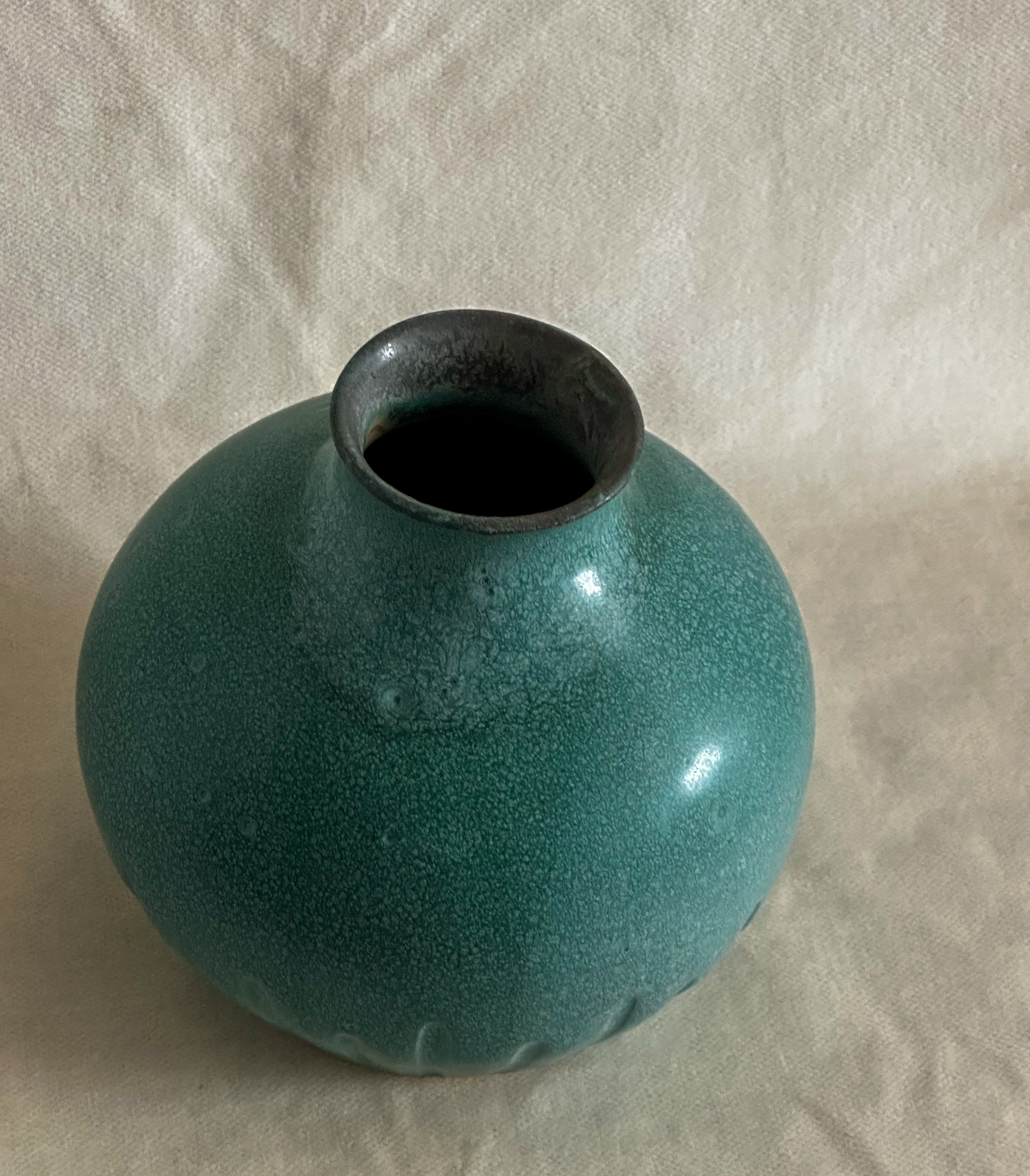 Carved vase in matte green
