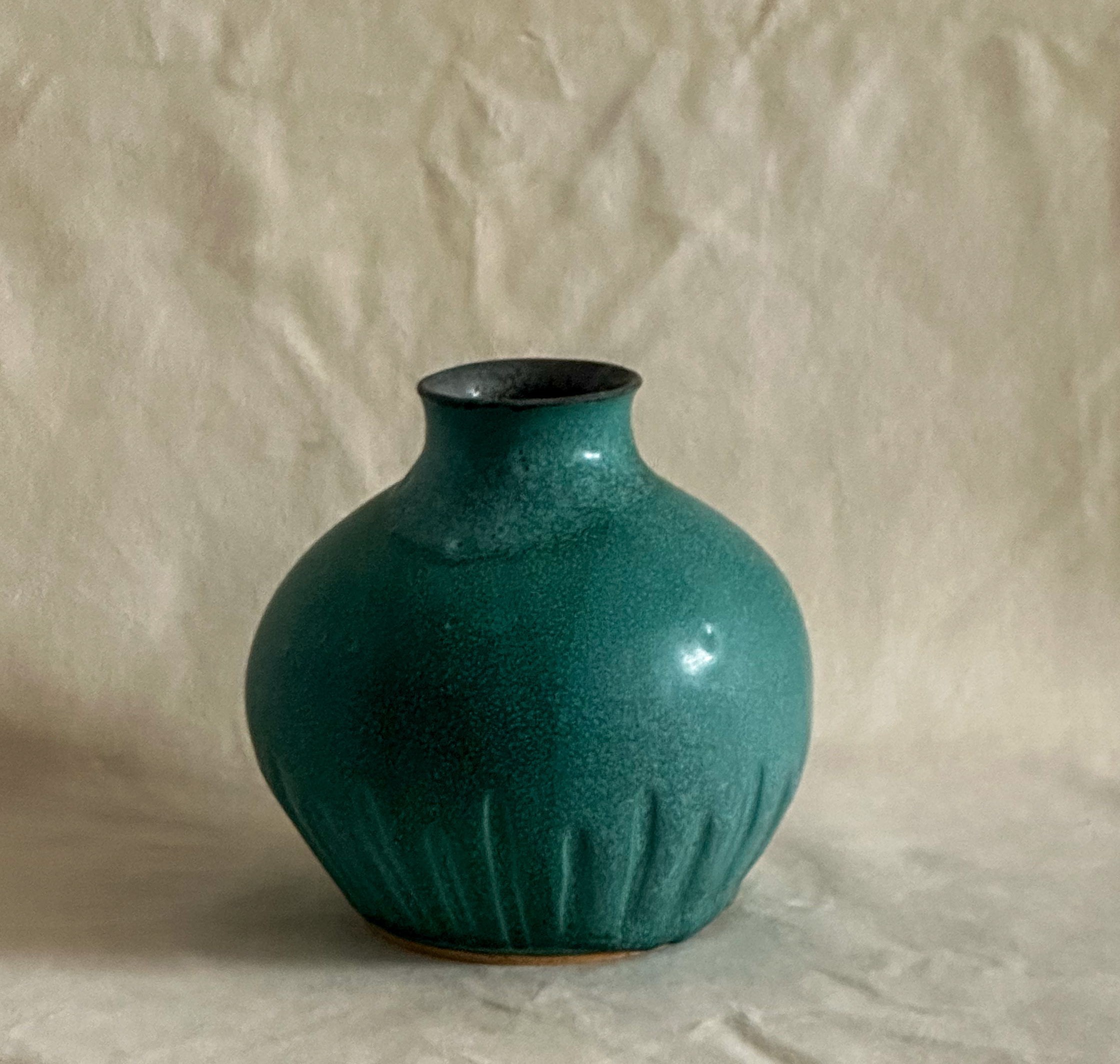 Carved vase in matte green