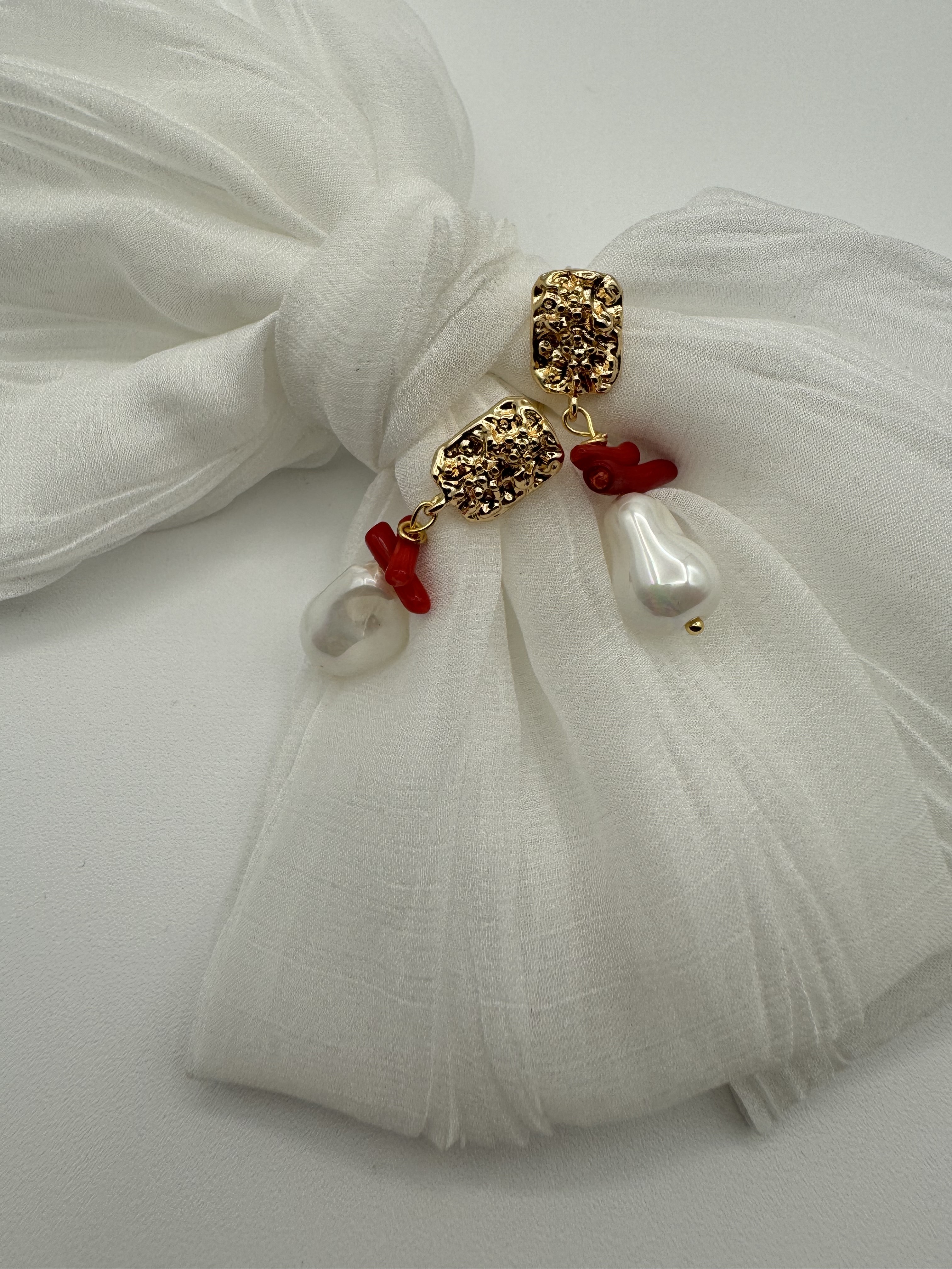 Gold textured earrings with baroque pearls and red coral
