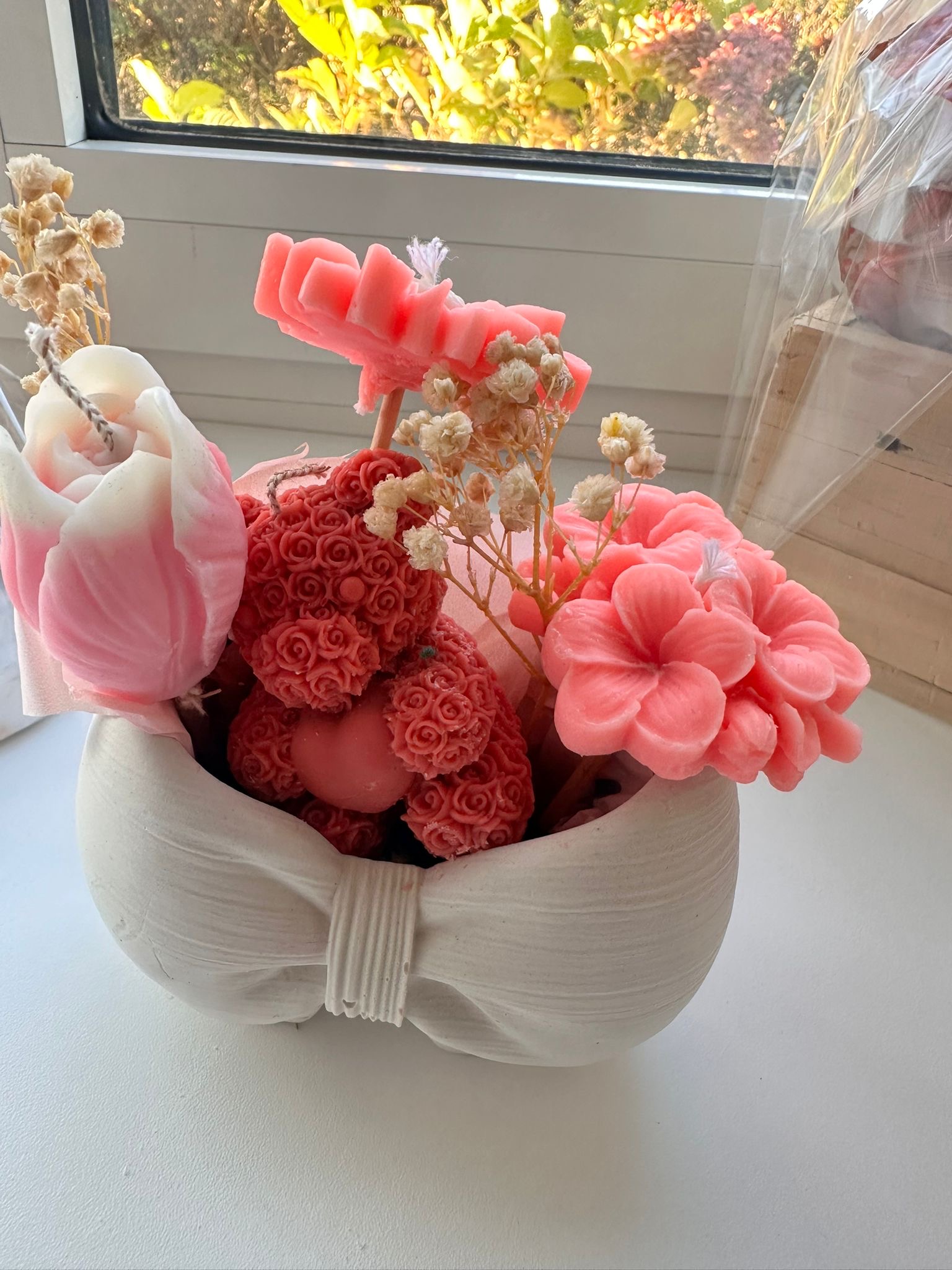A luxurious candle bouquet in a bow-shaped mold.