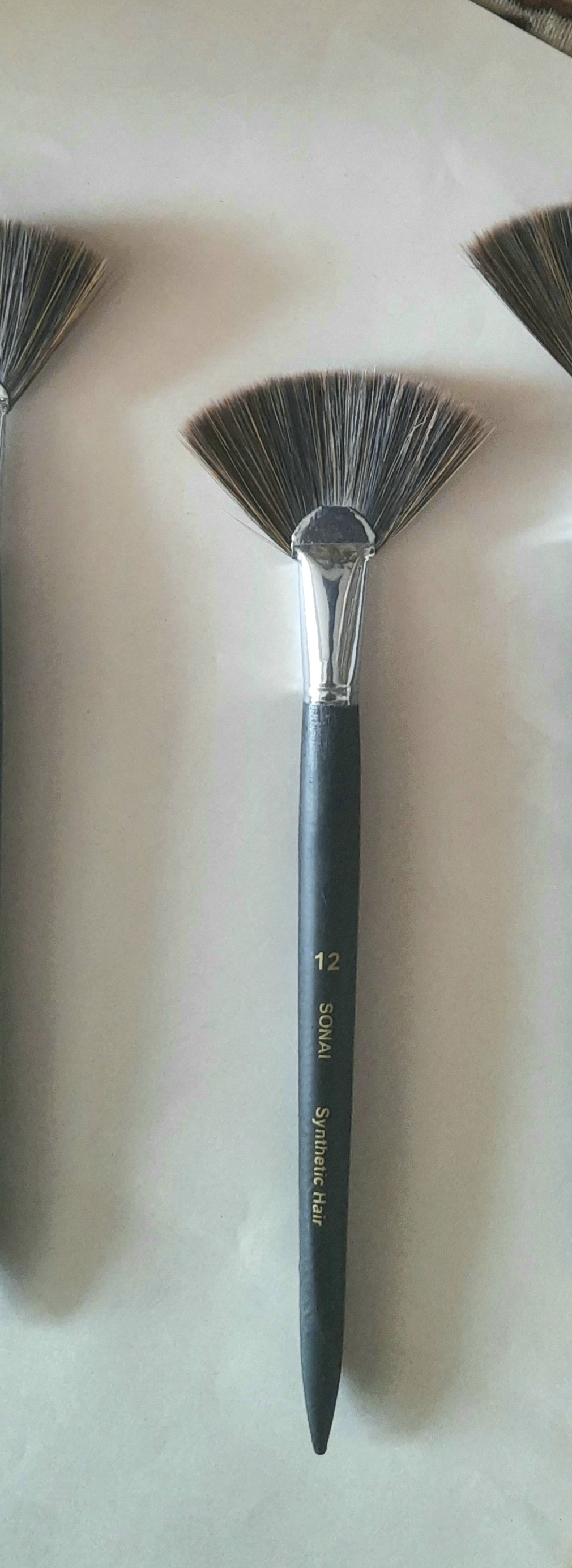 Fan blade brush