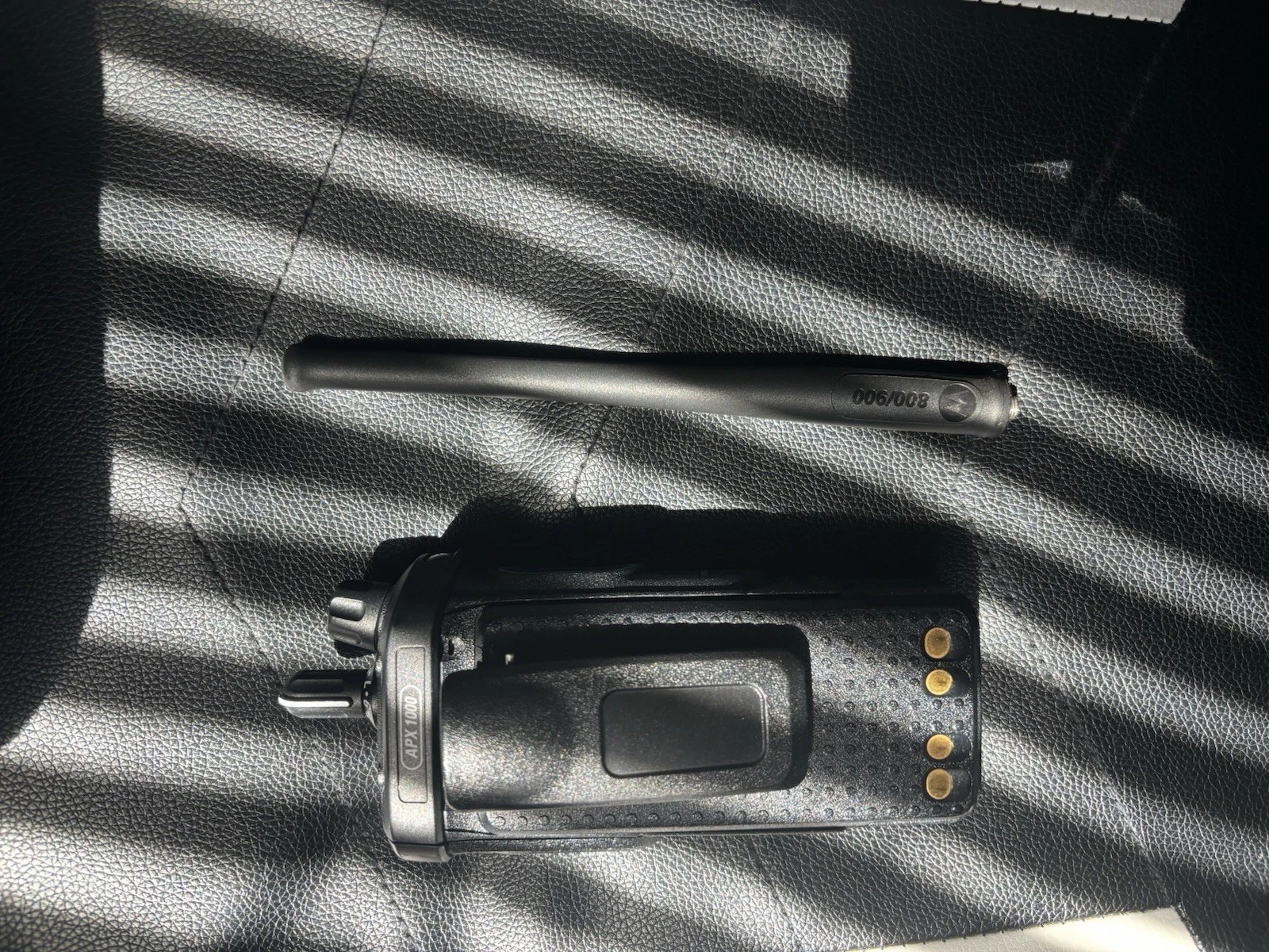 A Motorola Apx1000 with A Charger and A Programming Cord Tested