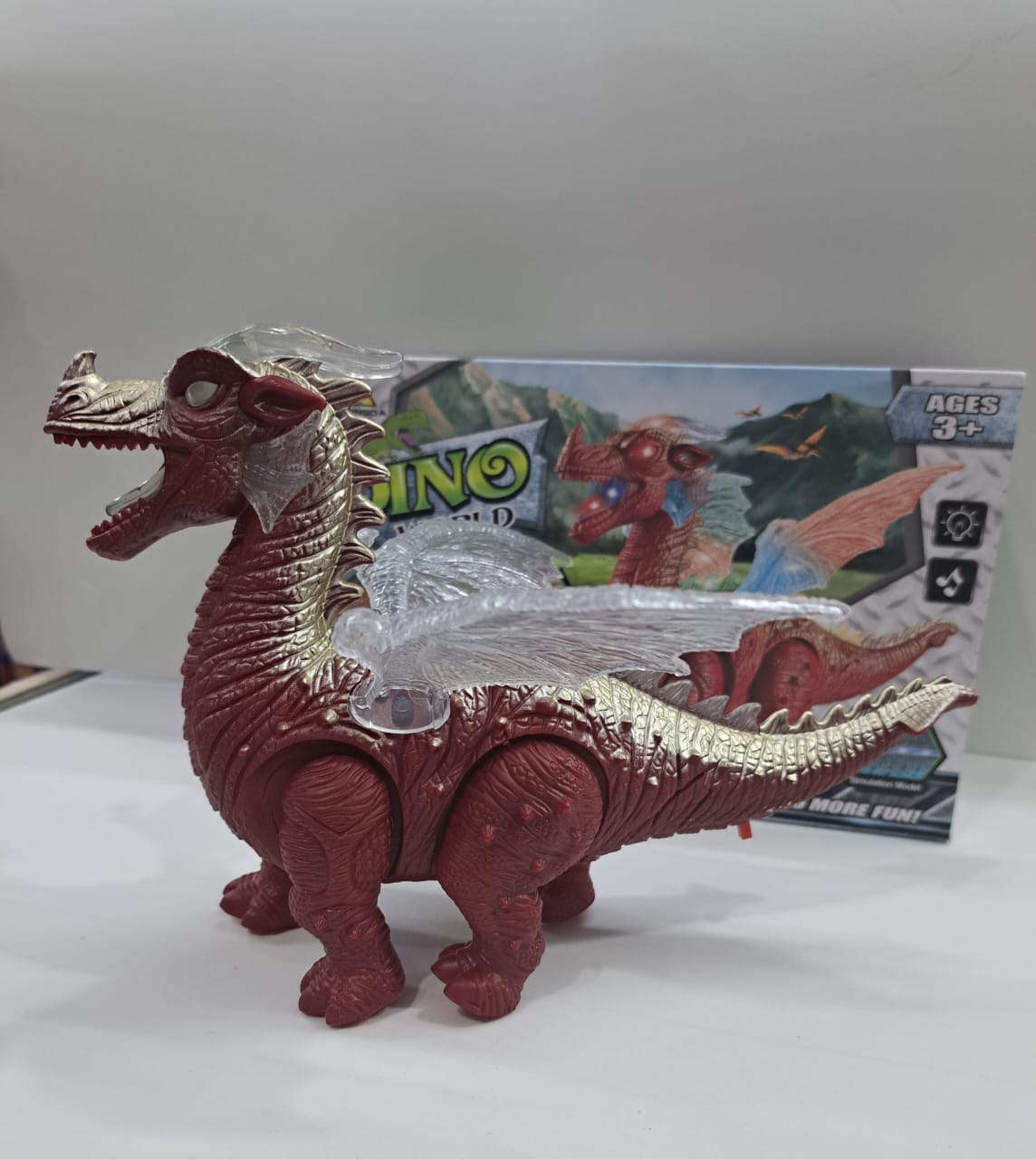 Dinosaurio de juguete rojo camina y luces