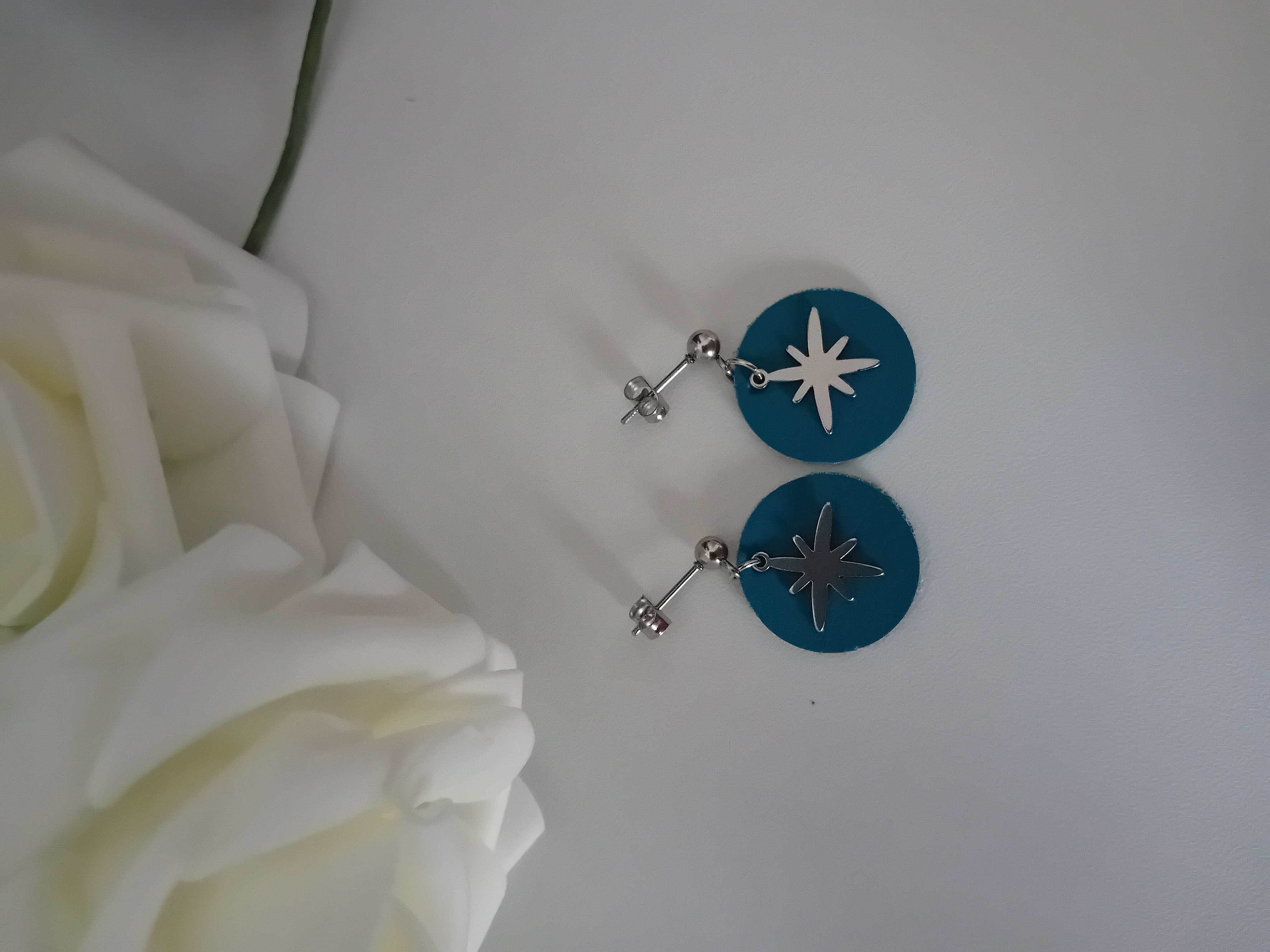 Boucle d'oreille étoile argenté et une élégance moderne en cuir turquoise