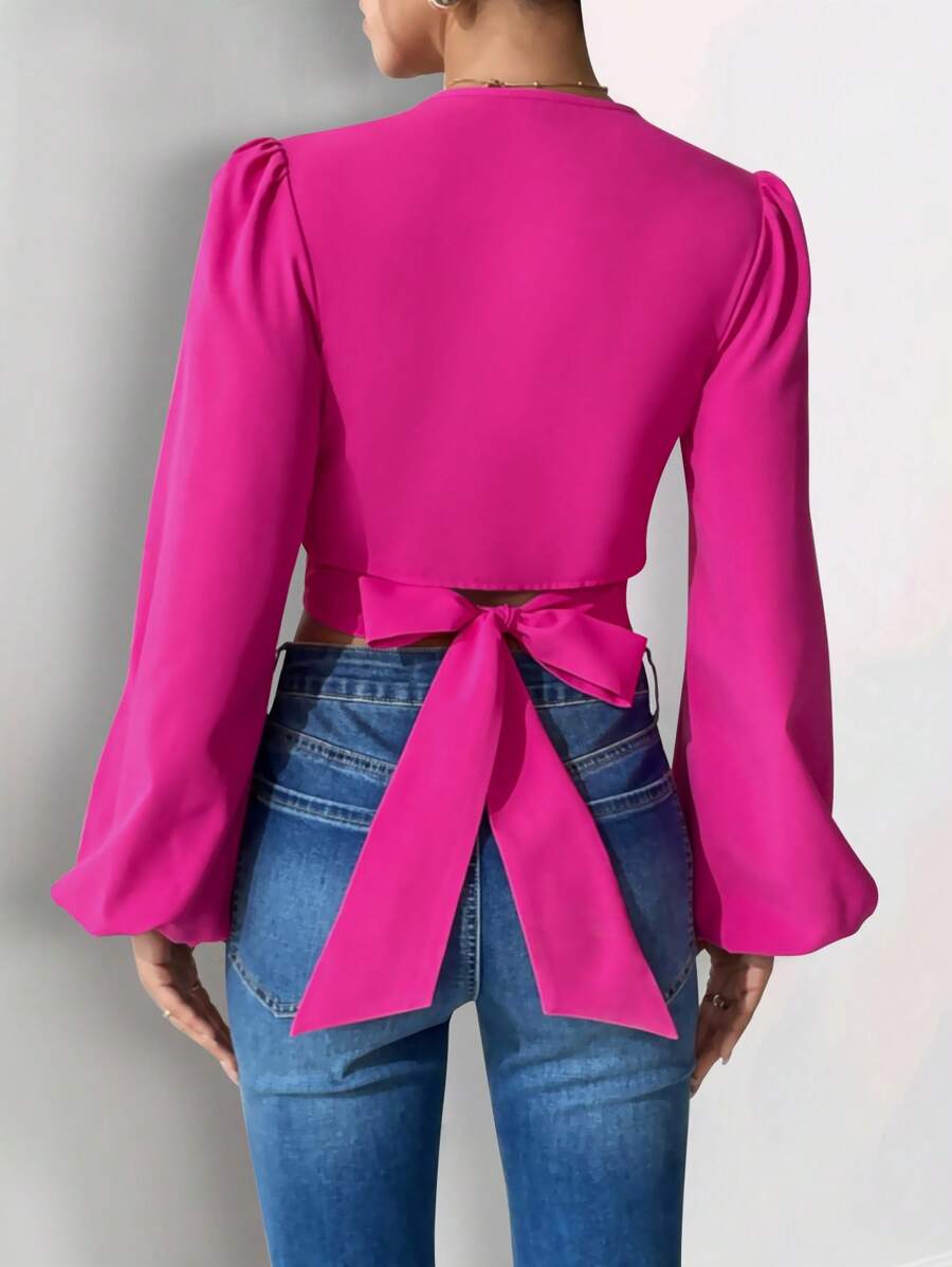 Blusa cruzada fucsia de manga larga
