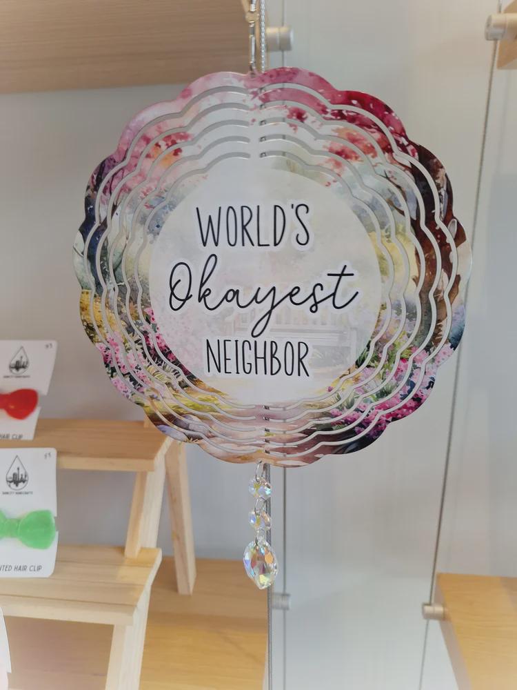 World's Okayest Neighbor 8 Inch Aluminum Wind Spinner With Glass Crystal Suncatcher