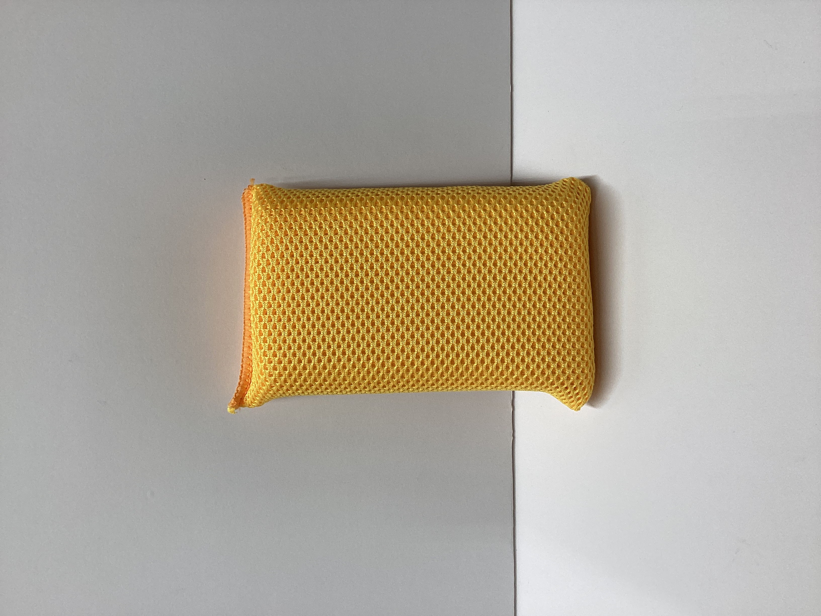 Yellow mesh cleaning sponge