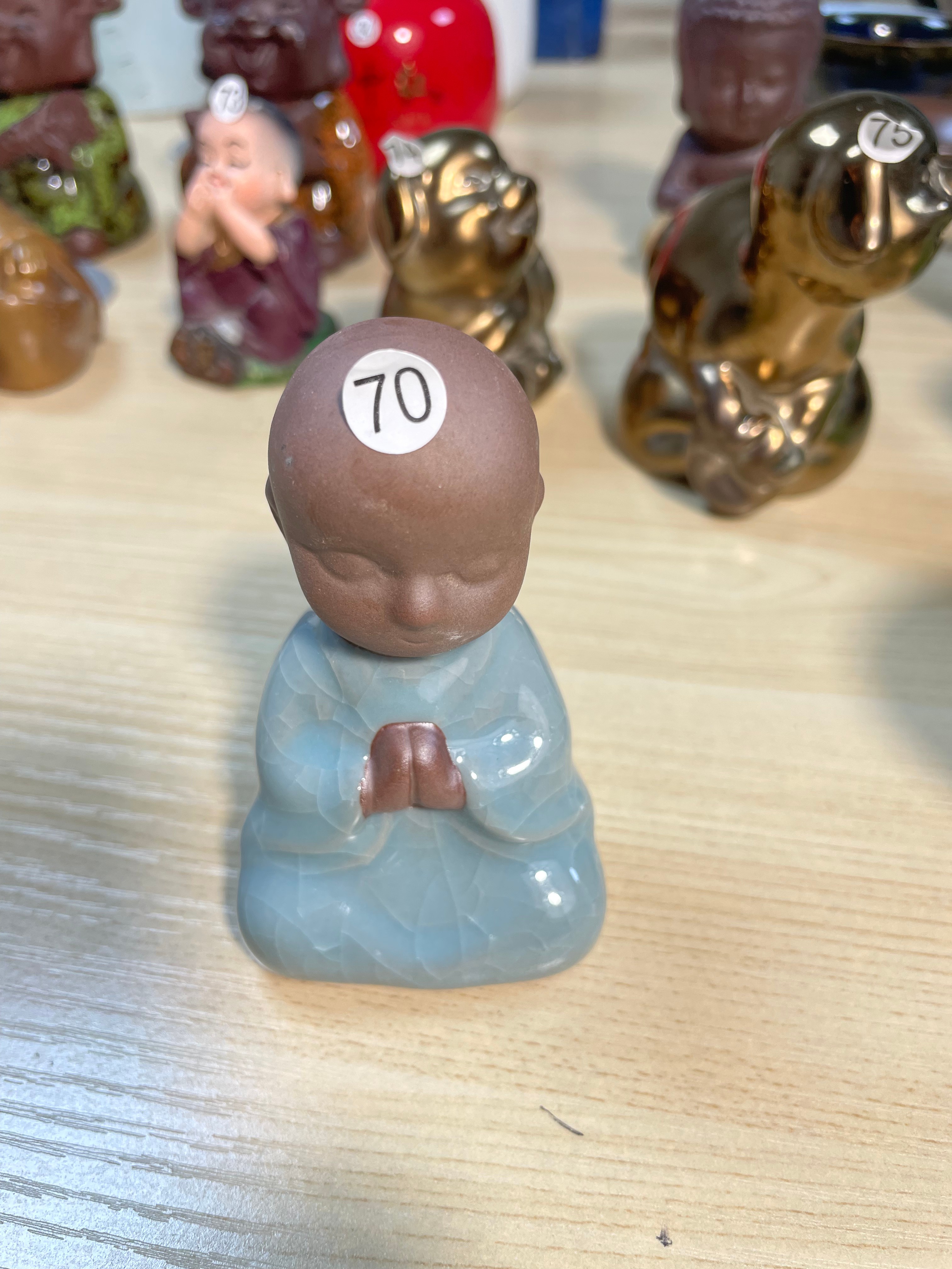 Ceramic praying monk figurine
