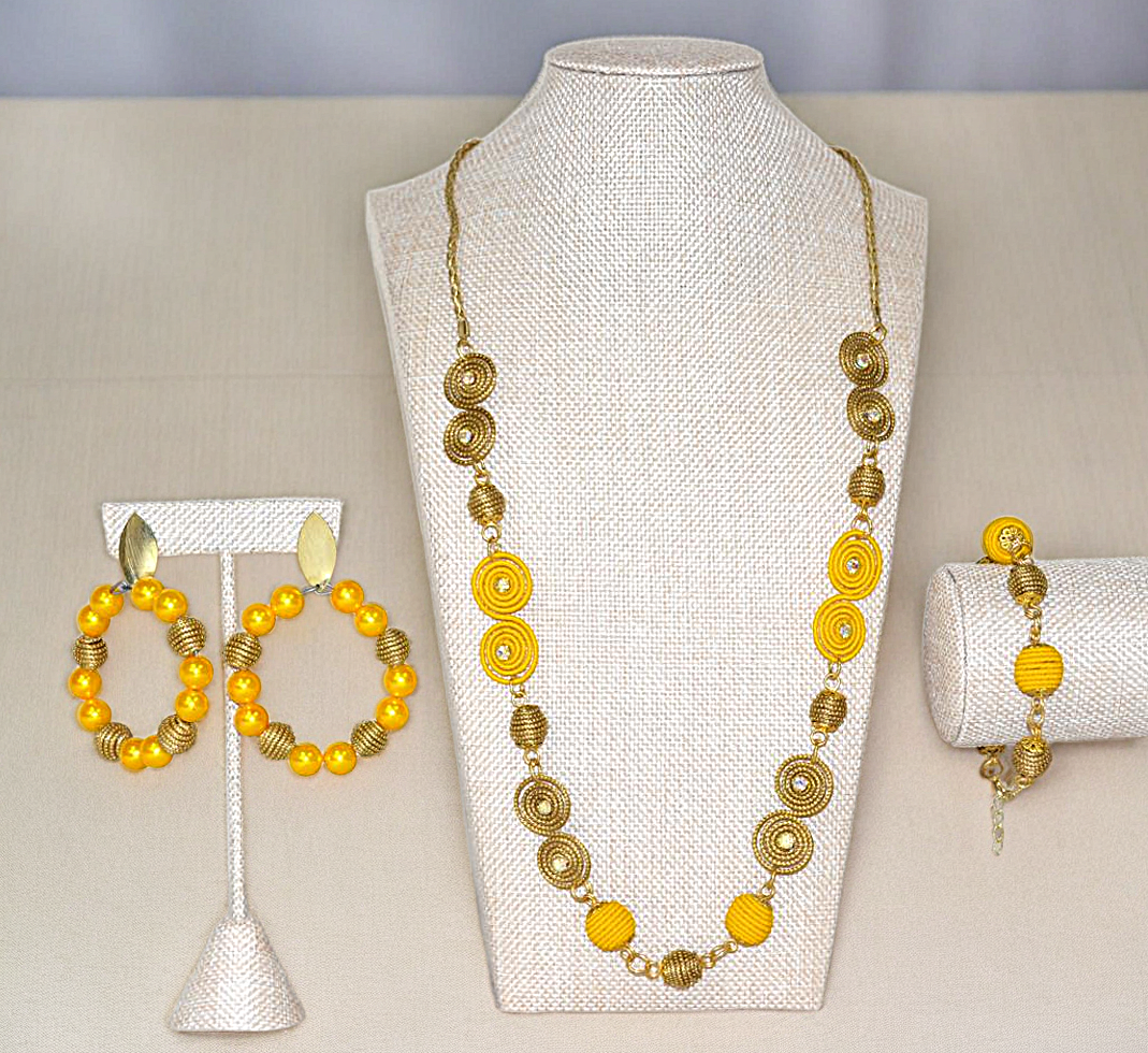 Elegant Necklace, hoop Earrings, and Bracelet on yellow and Golden Color