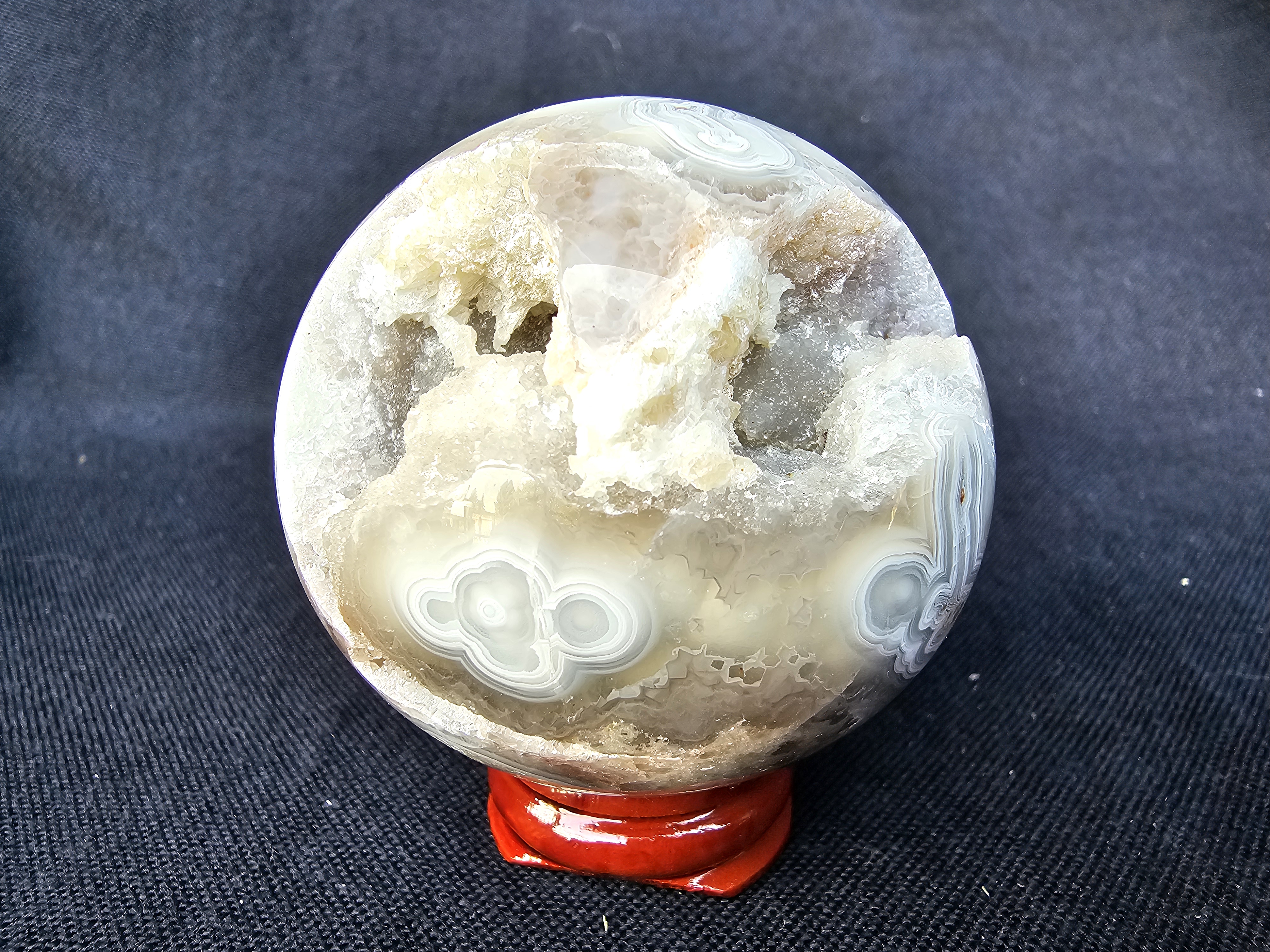 Unique Crazy Lace Agate sphere with drusy cave