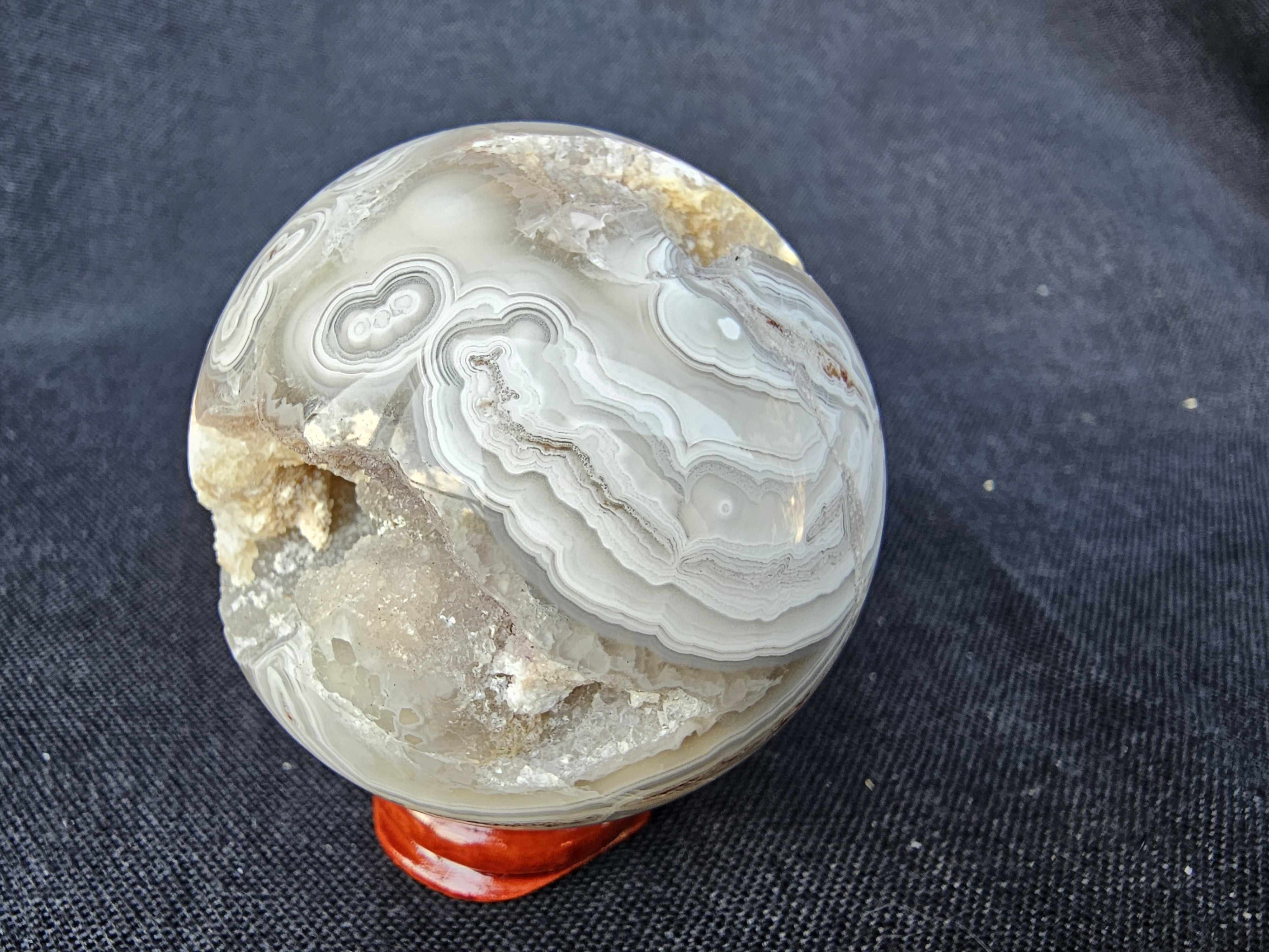 Unique Crazy Lace Agate sphere with drusy cave