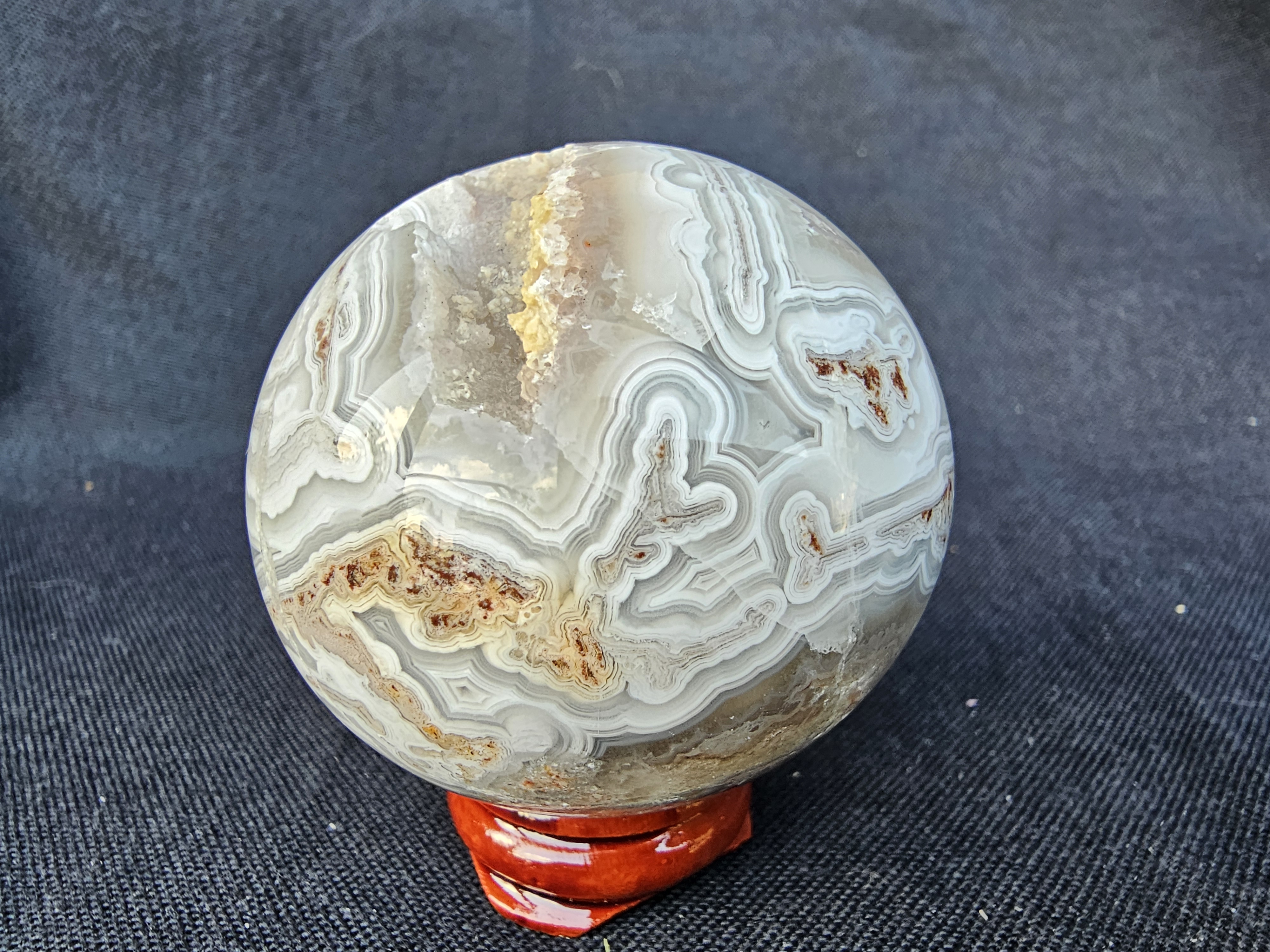 Unique Crazy Lace Agate sphere with drusy cave