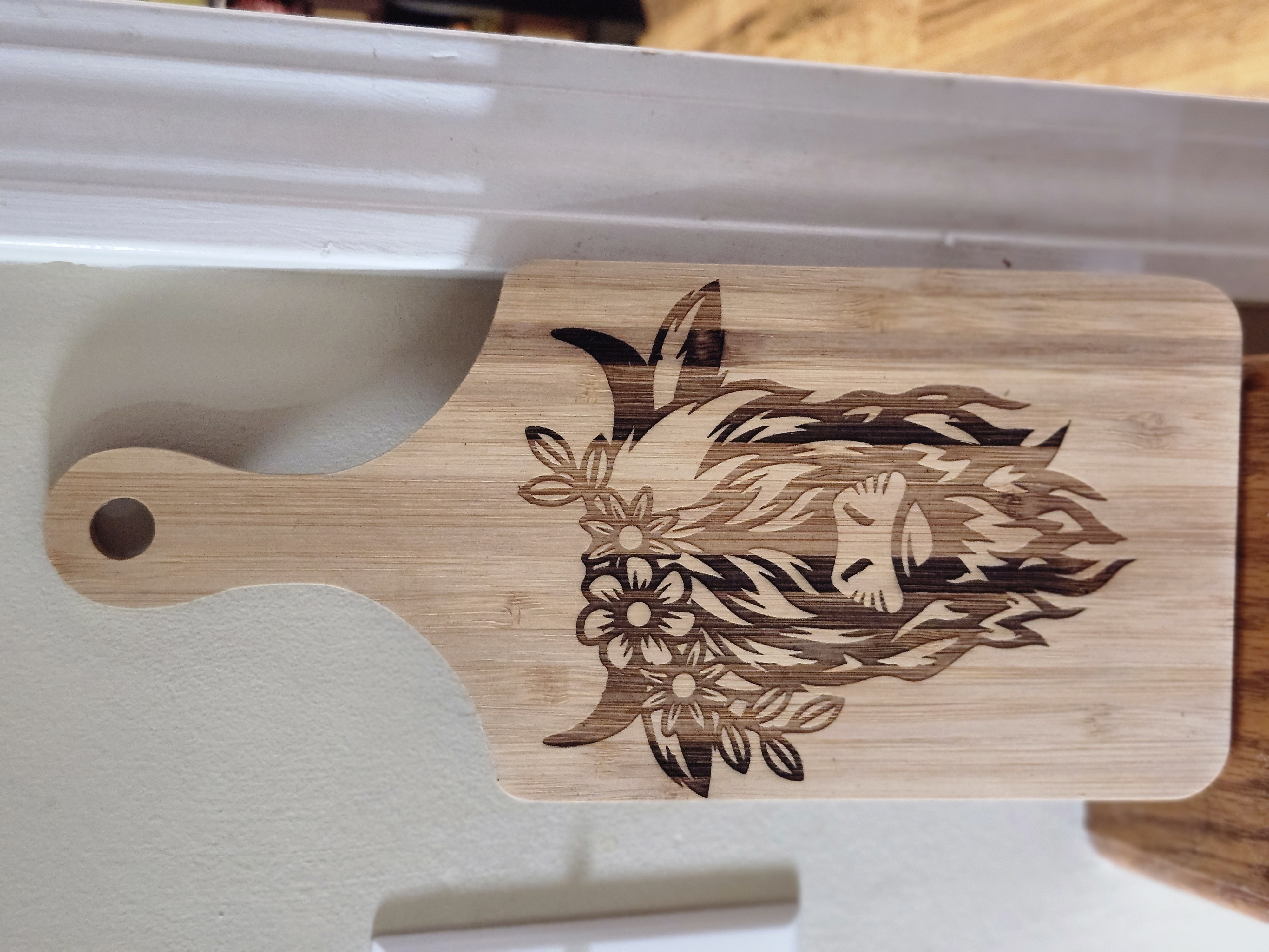 Wooden cutting board with engraved highland cow design