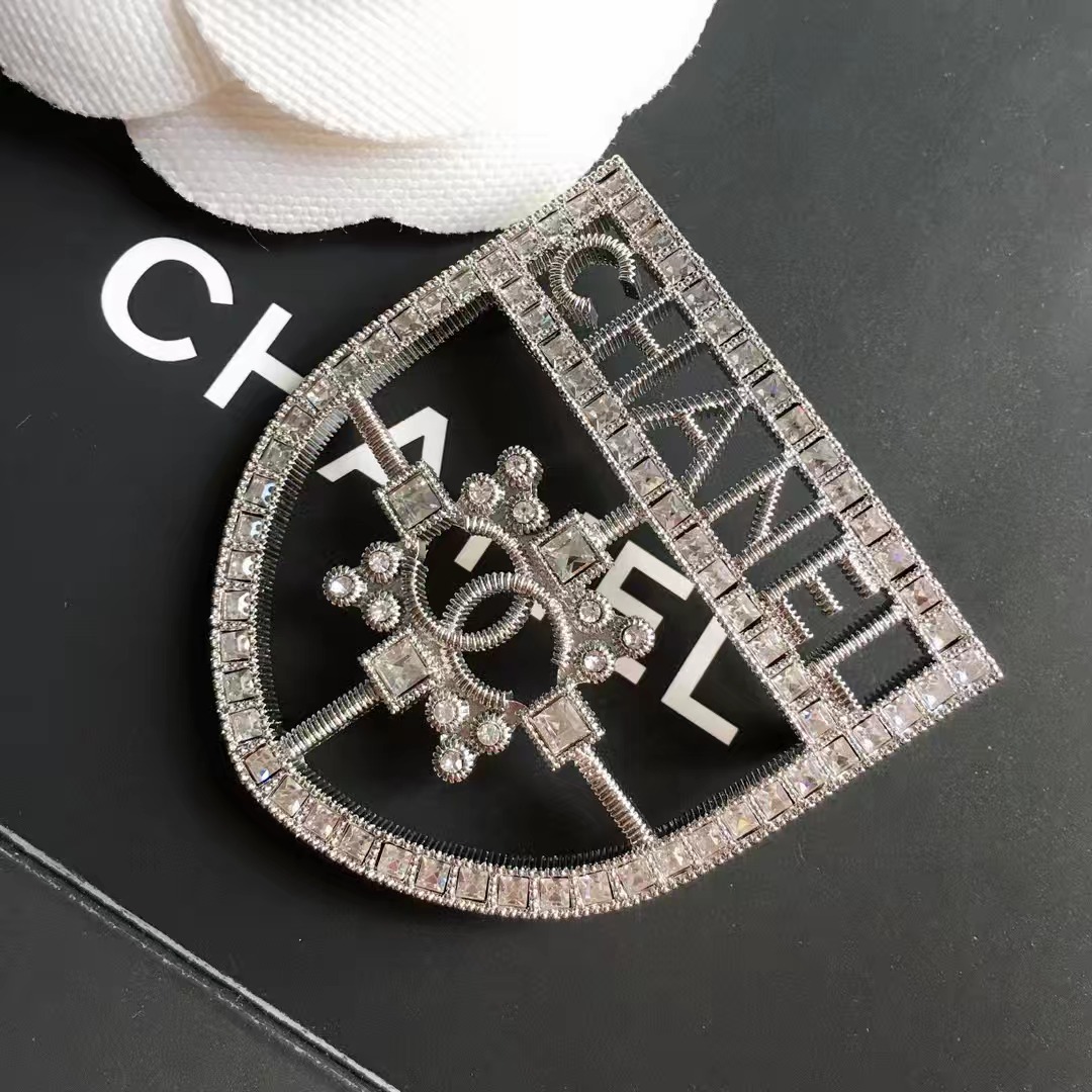  Silver-Tone Shield-Shaped Brooch with Crystal Embellishments