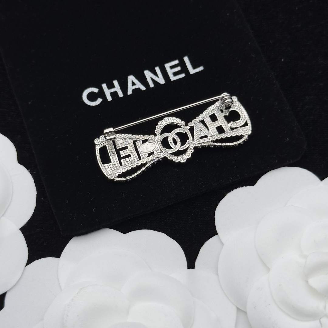 Silver-Tone Brooch with Crystal Lettering & Central Motif