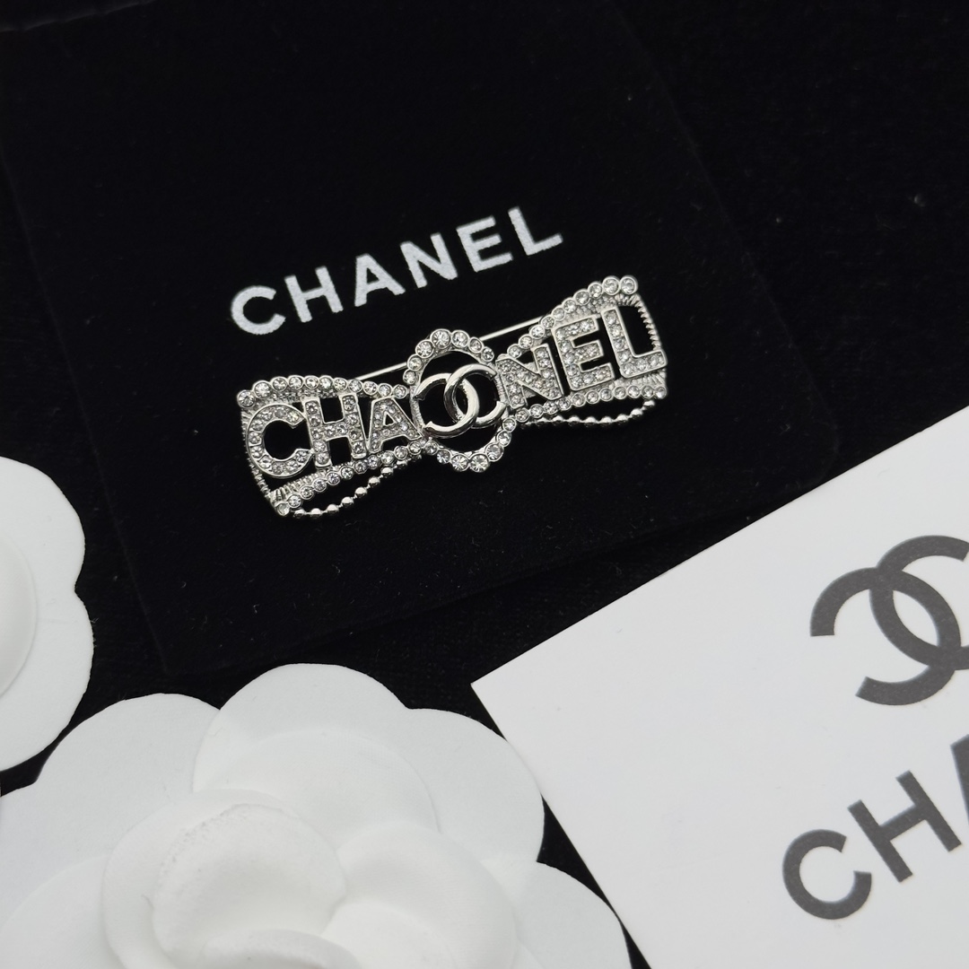 Silver-Tone Brooch with Crystal Lettering & Central Motif