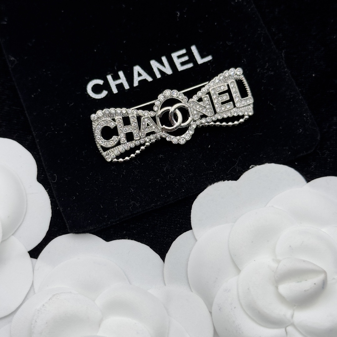 Silver-Tone Brooch with Crystal Lettering & Central Motif