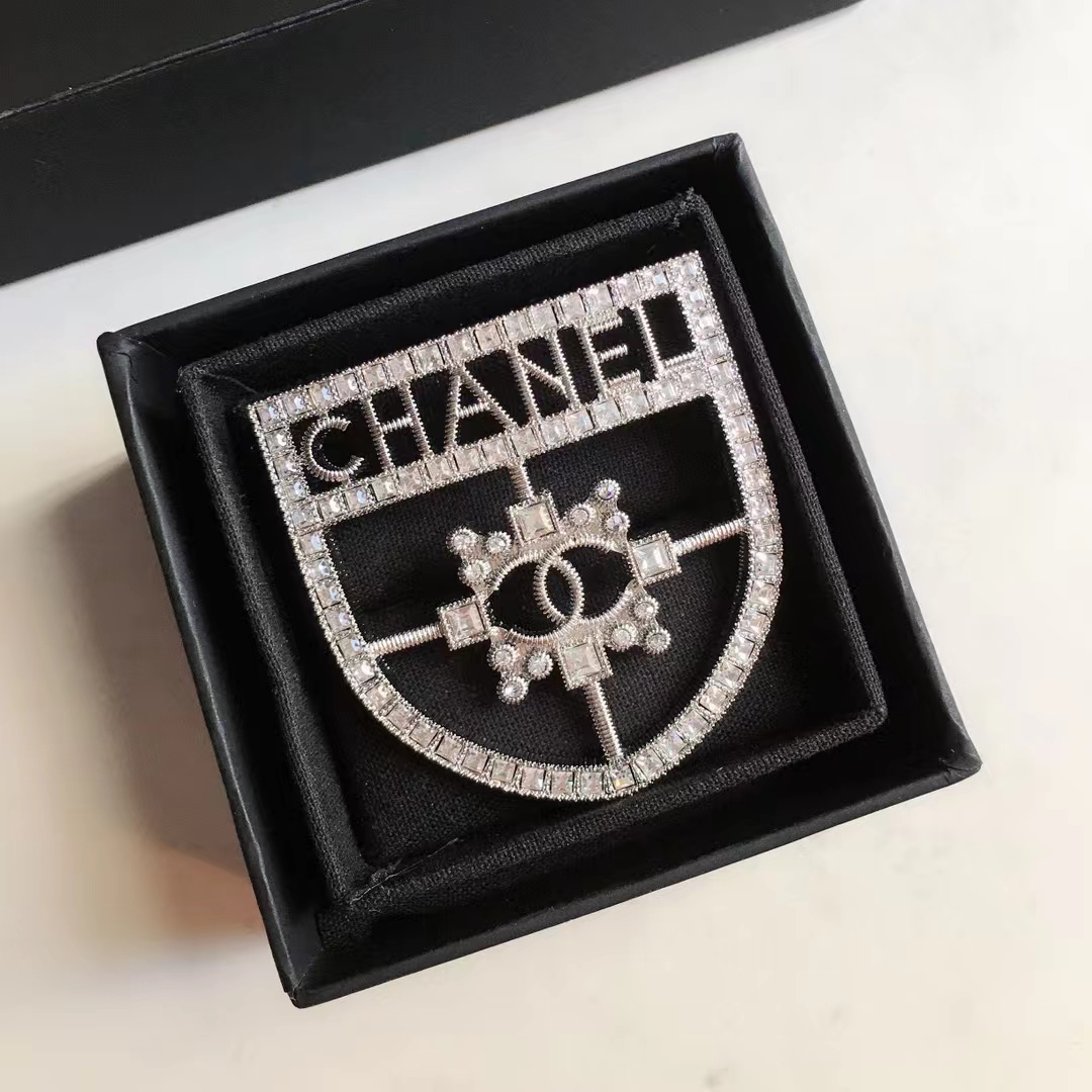  Silver-Tone Shield-Shaped Brooch with Crystal Embellishments