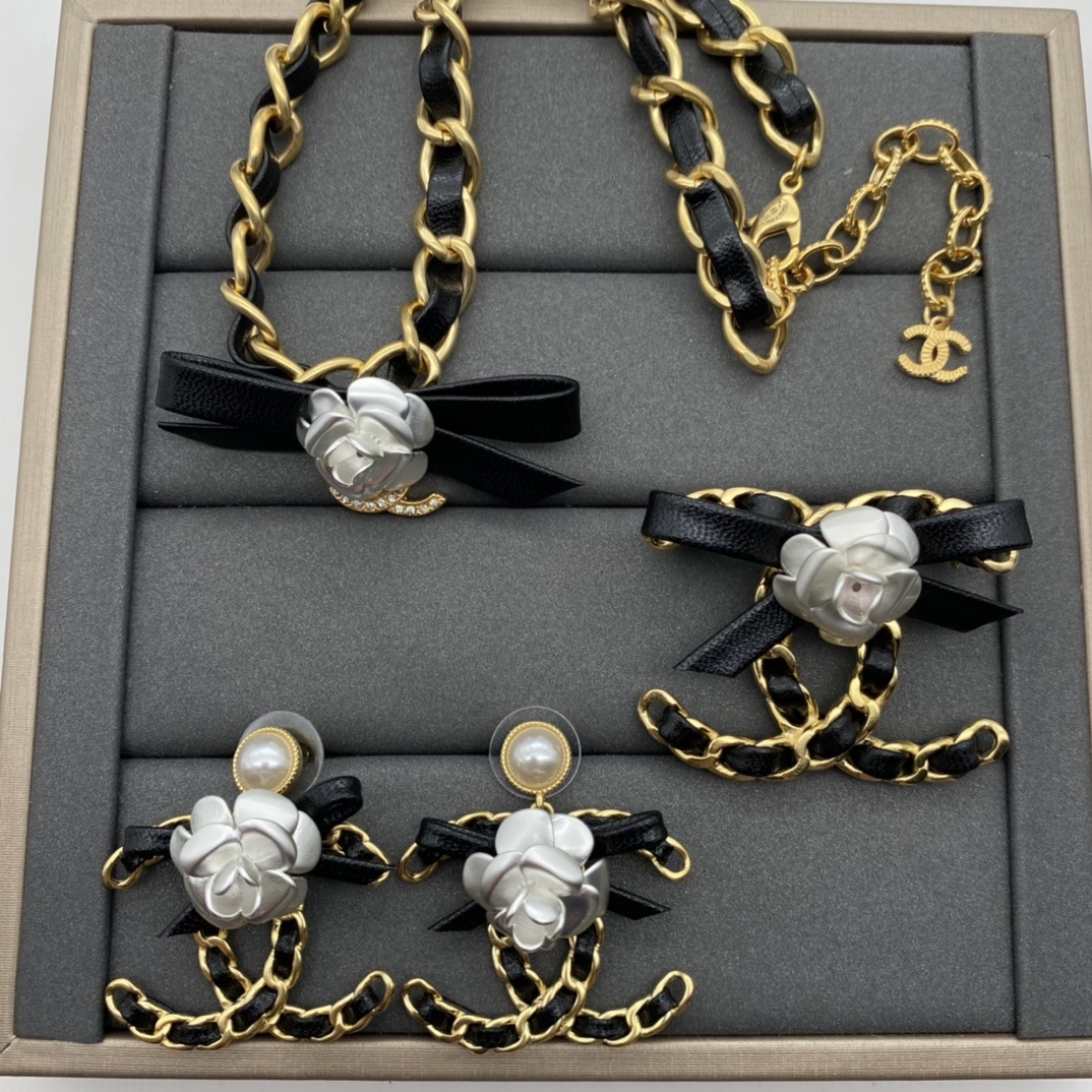 Jewelry Set with Black PU Leather, Camellia, and Interlocking Detail Accents in Gold Tones