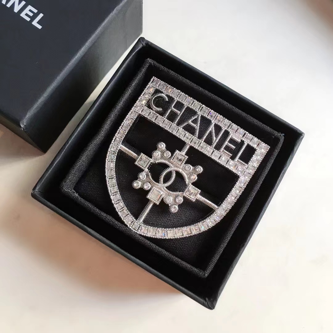  Silver-Tone Shield-Shaped Brooch with Crystal Embellishments