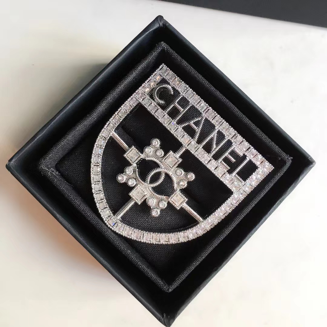  Silver-Tone Shield-Shaped Brooch with Crystal Embellishments