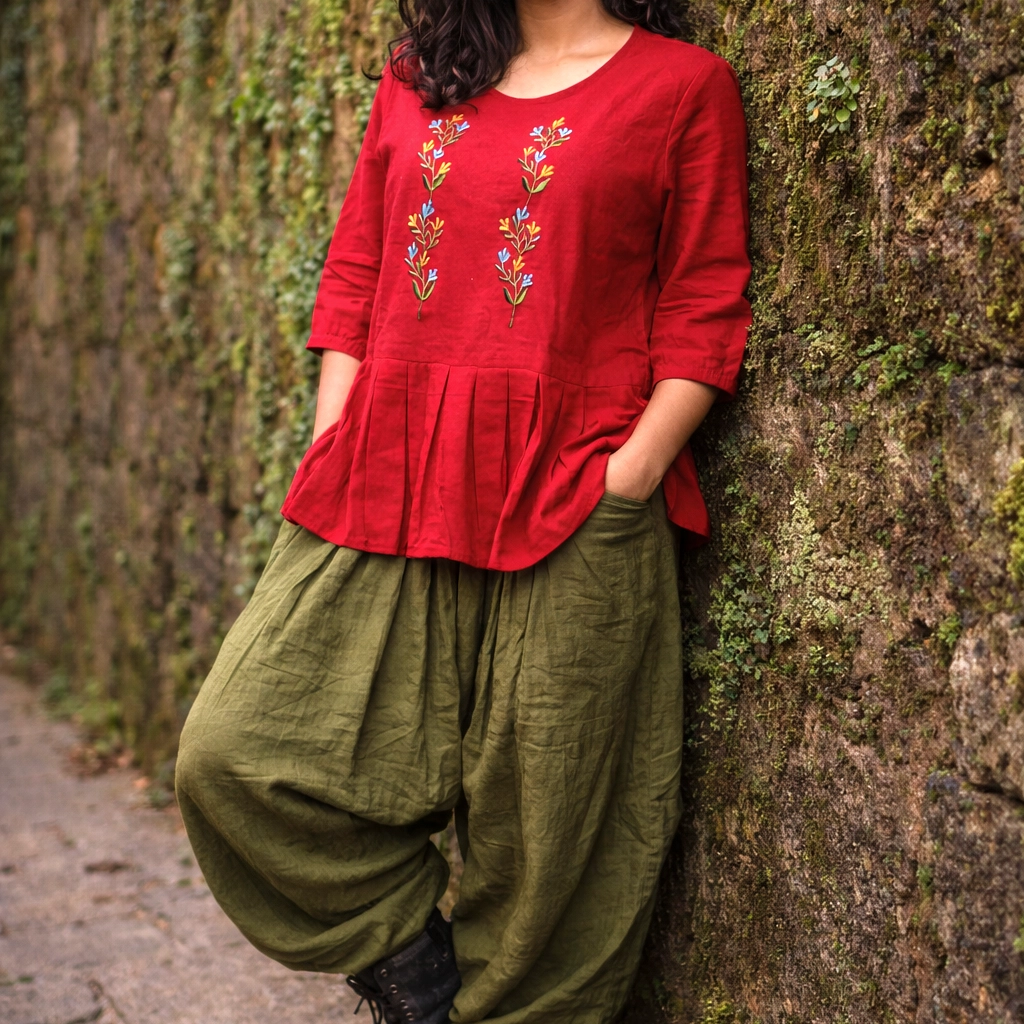 SUNNY BLISS - Peplum Hem Fitted pleated V Neck Sleeveless Top in Haze Red.