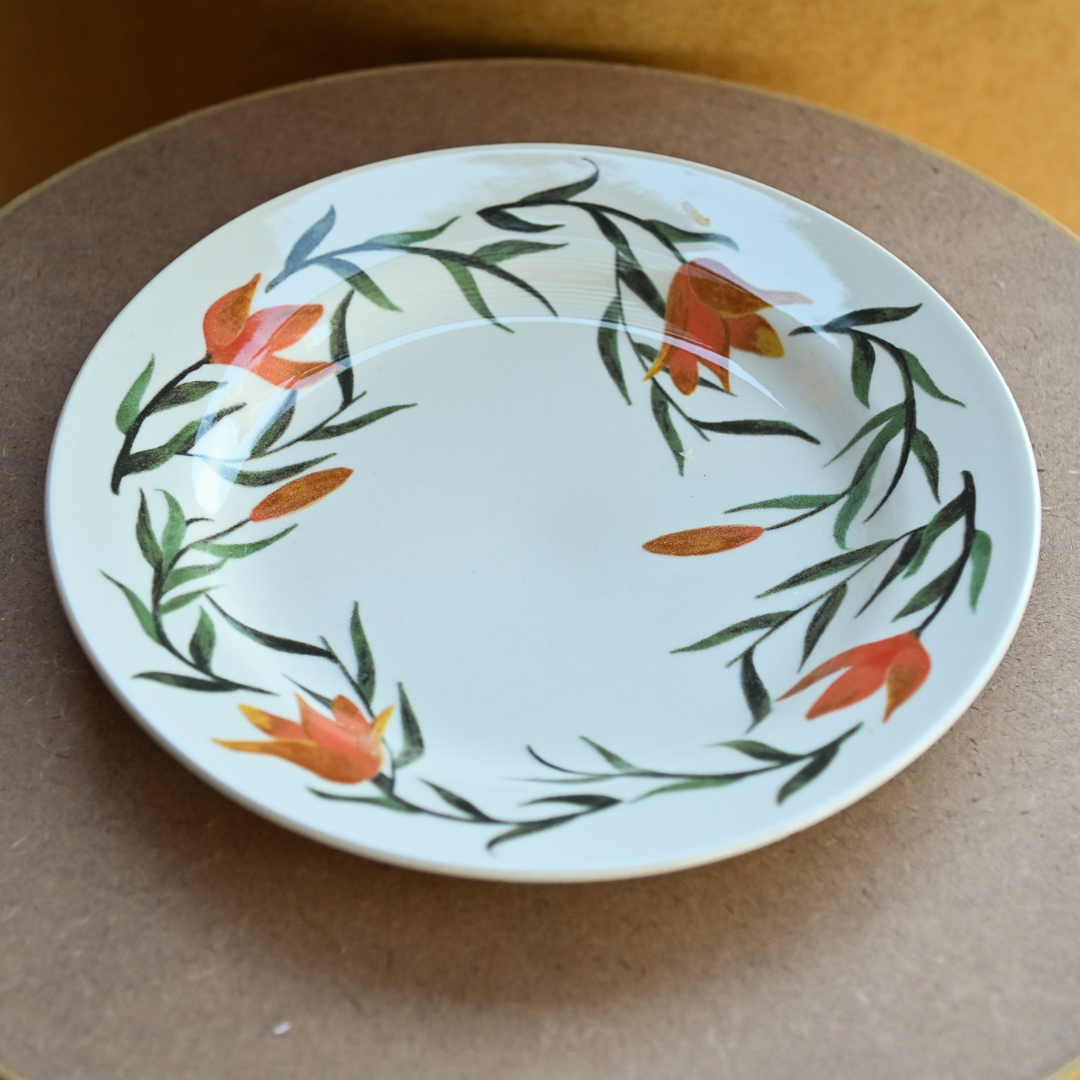 Prato raso em cerâmica esmaltada com estampa floral em laranja