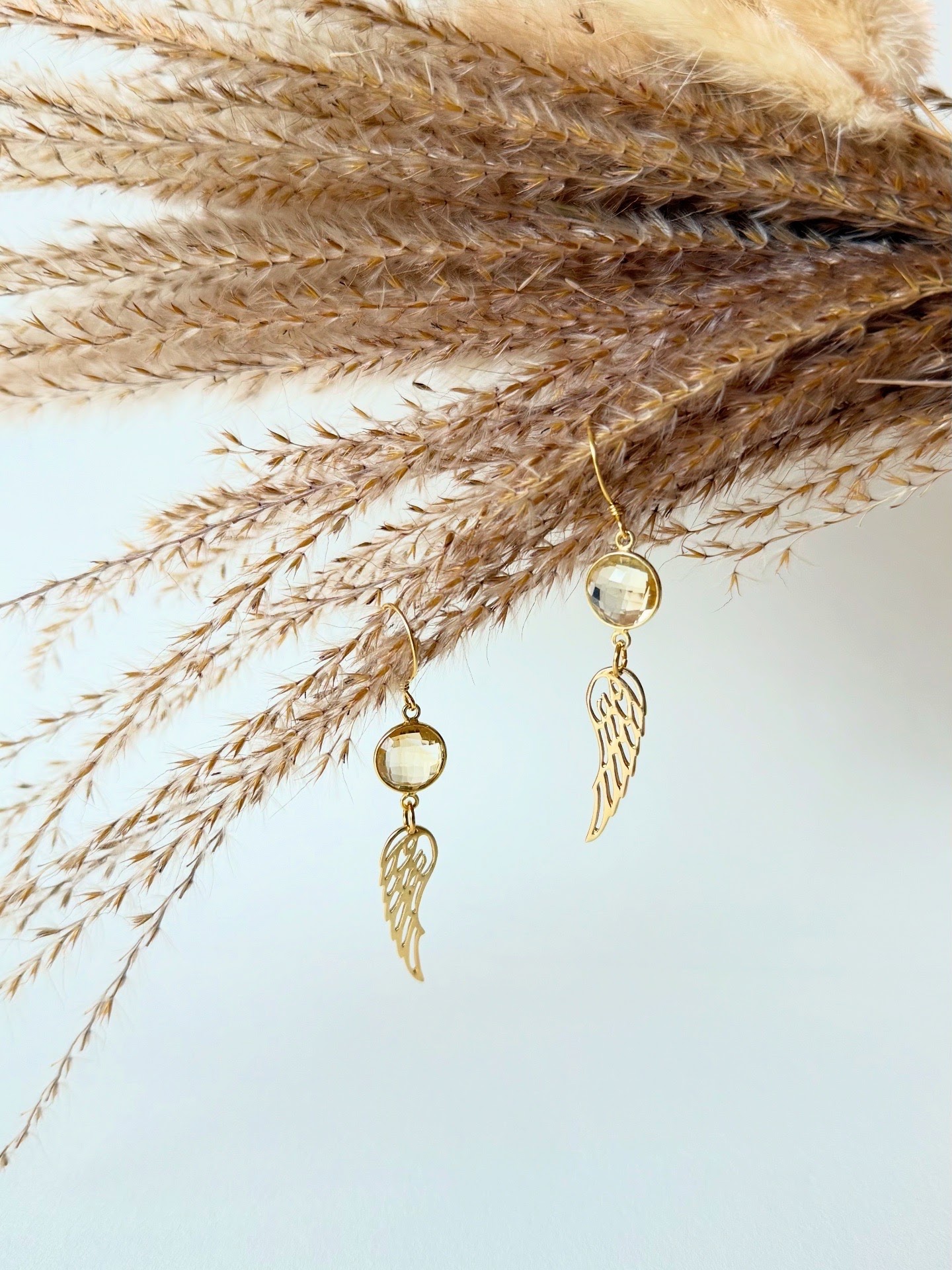 Citrine and gold feather element dangling earrings
