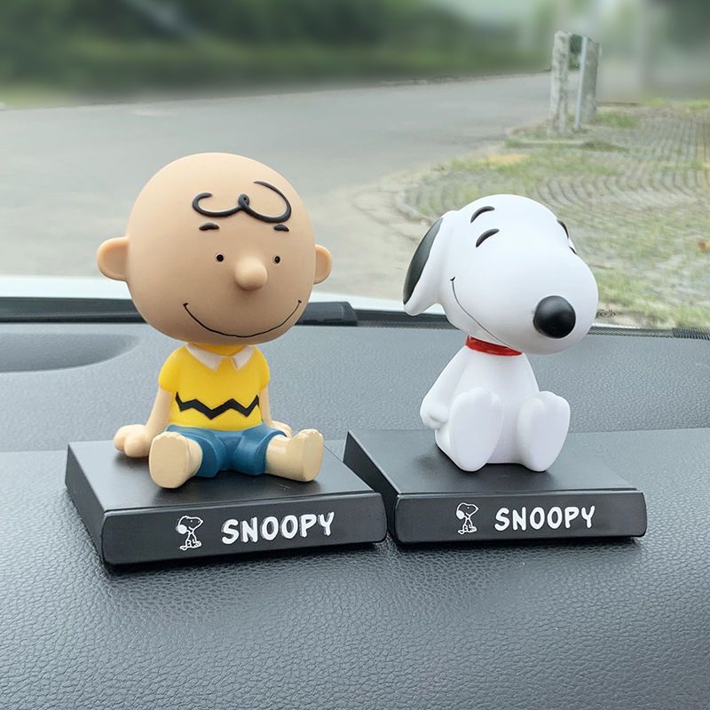Snoopy and Charlie Brown shaking head figurines phone holder