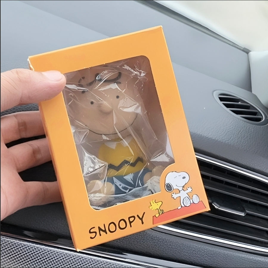 Snoopy and Charlie Brown shaking head figurines phone holder