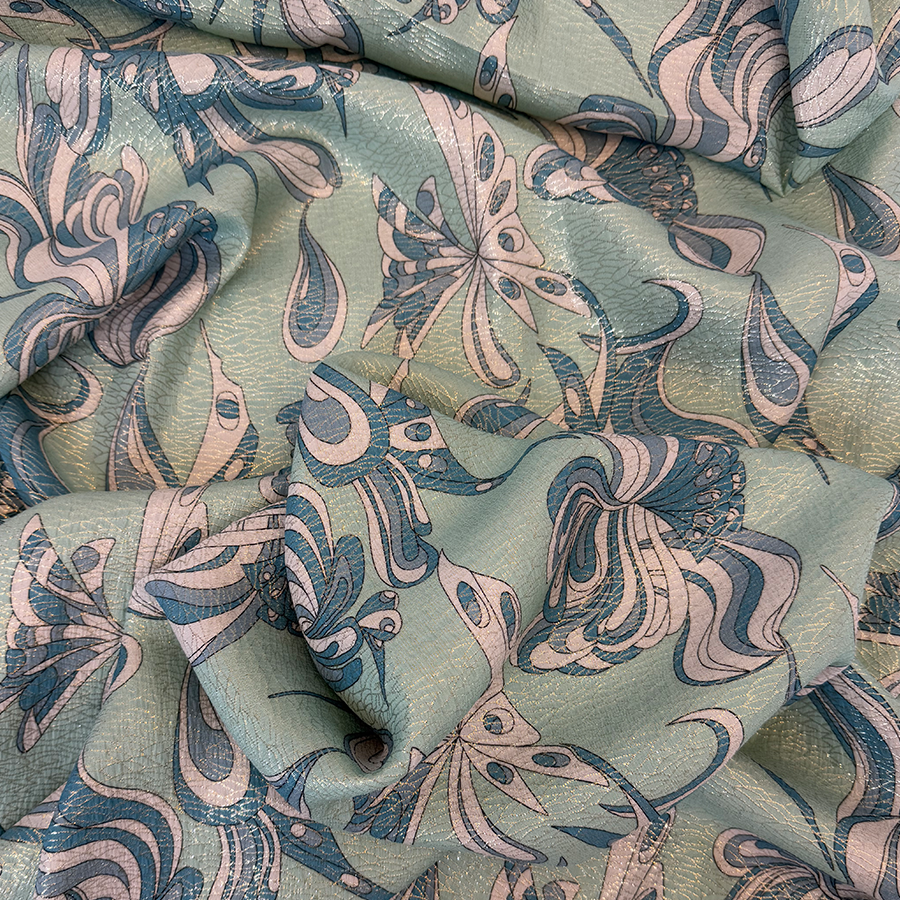 نقشة فراشات باللون الأزرق على خلفية خضراء فاتحة