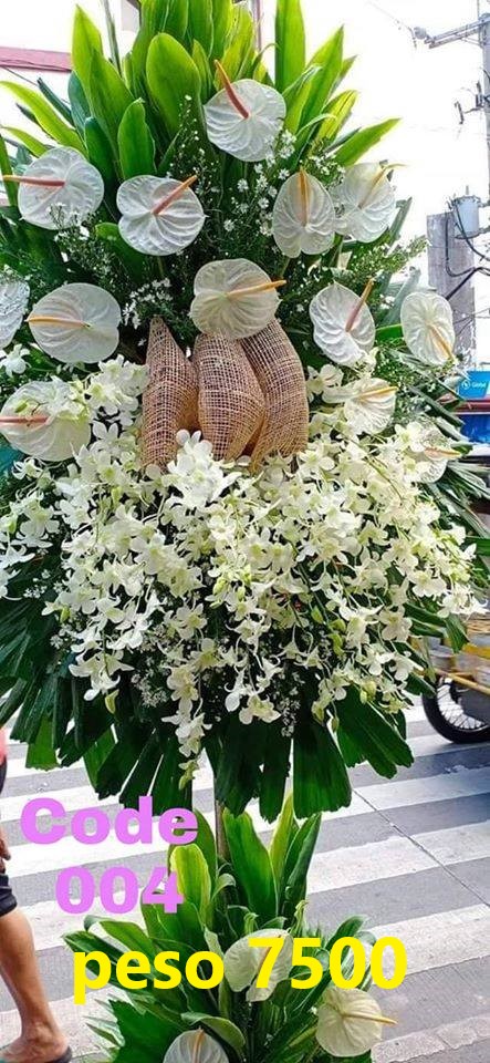 Elegant sympathy tribute with orchids & white anthurium
