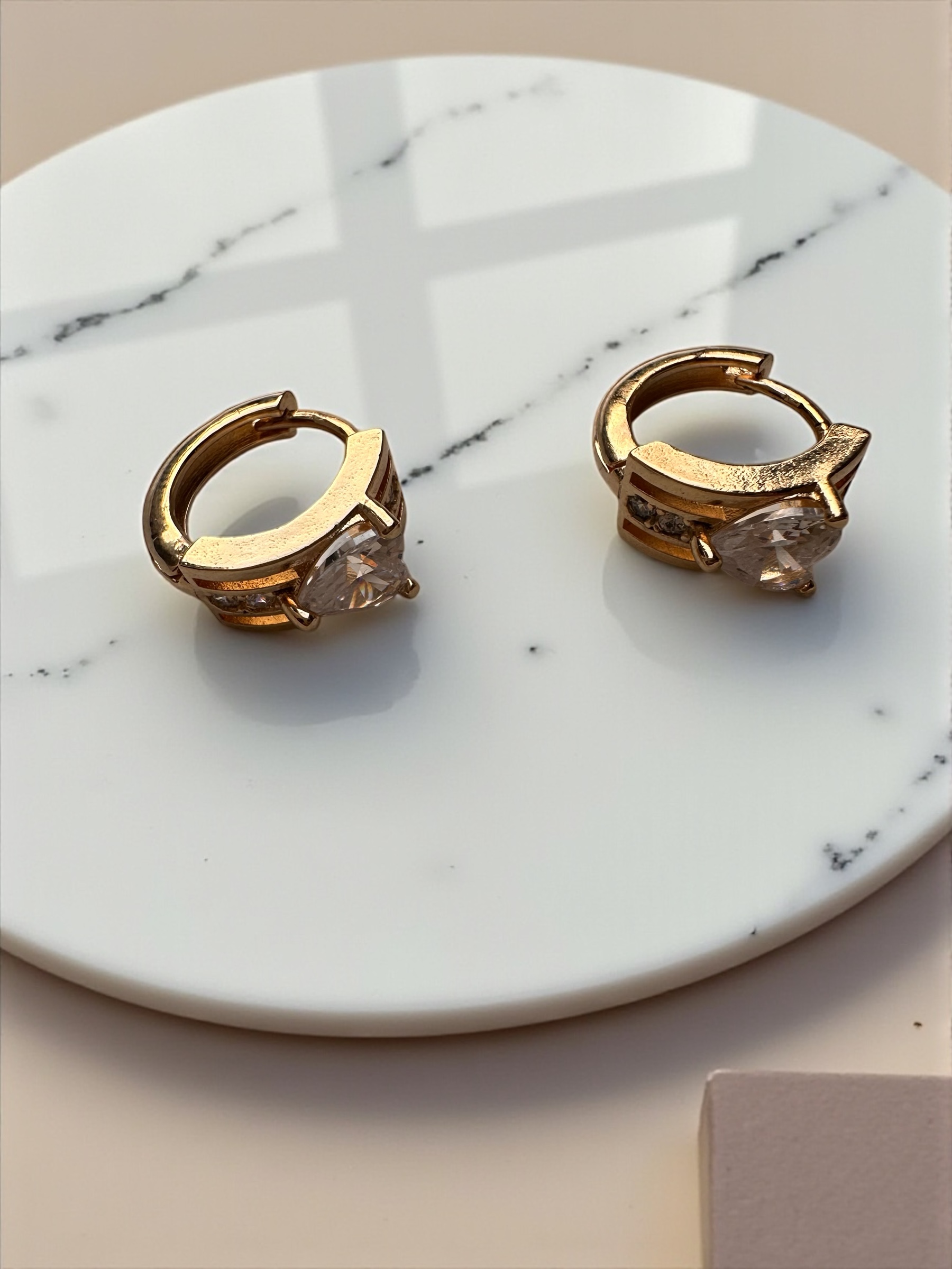 Par de brincos dourados com pedra