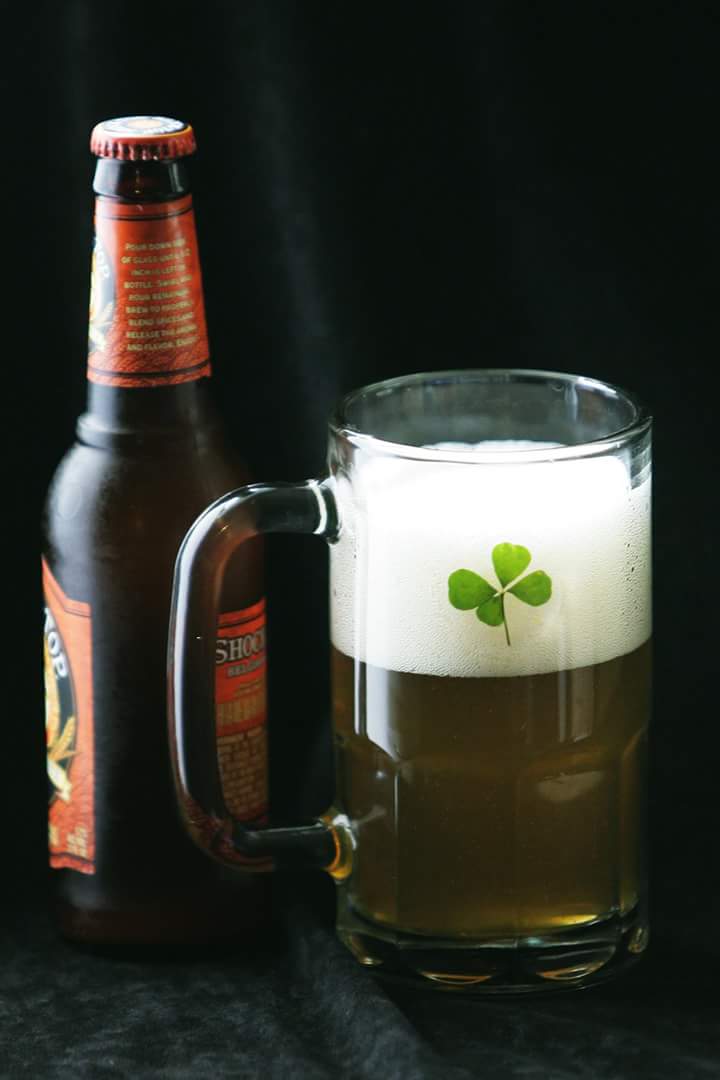 Beer Mug with four leaf clovers carefully affixed to the glass