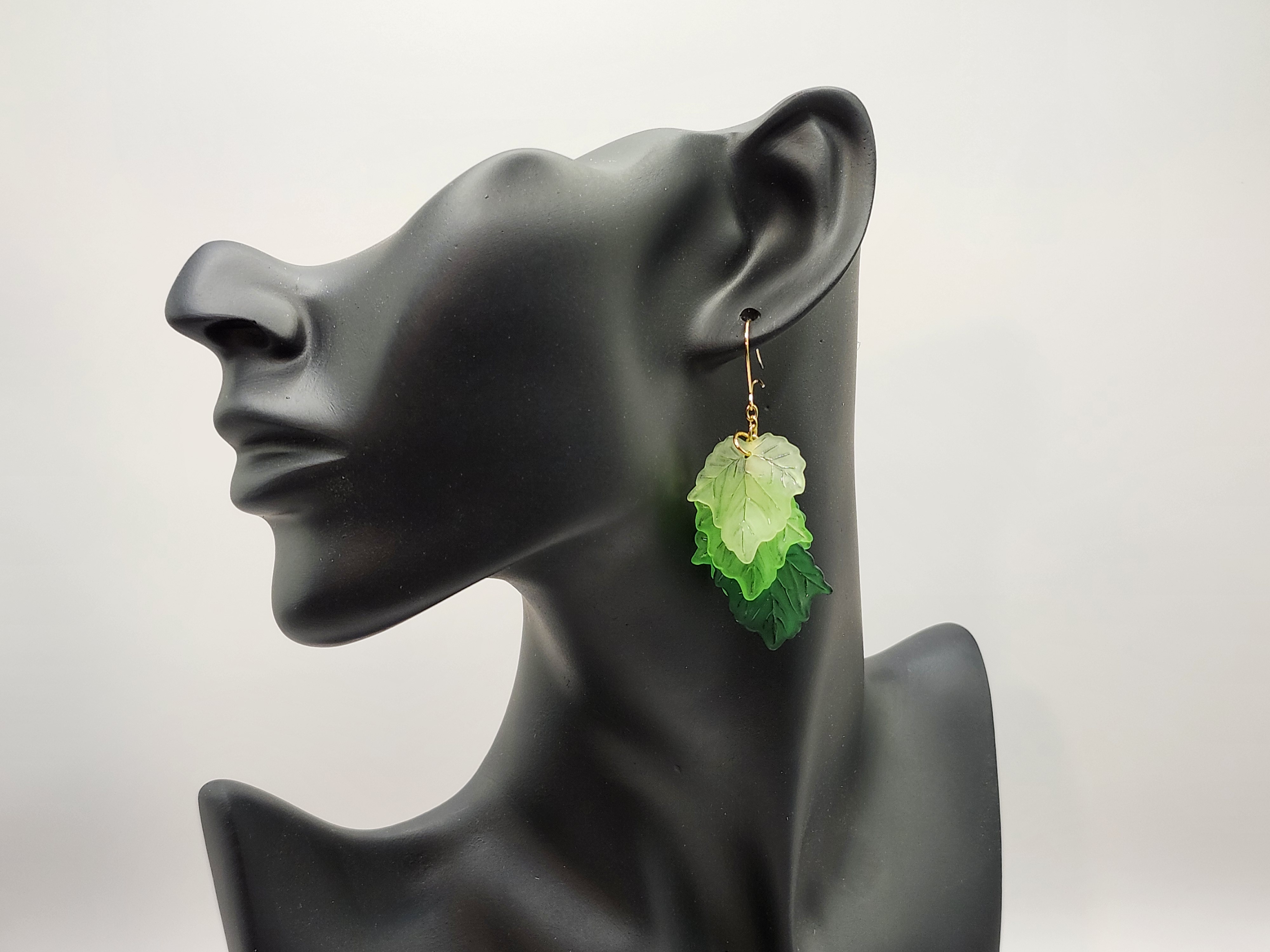 Handcrafted green leaf dangle earrings with gold chain accents. Lightweight, nature-inspired hypoallergenic jewelry
