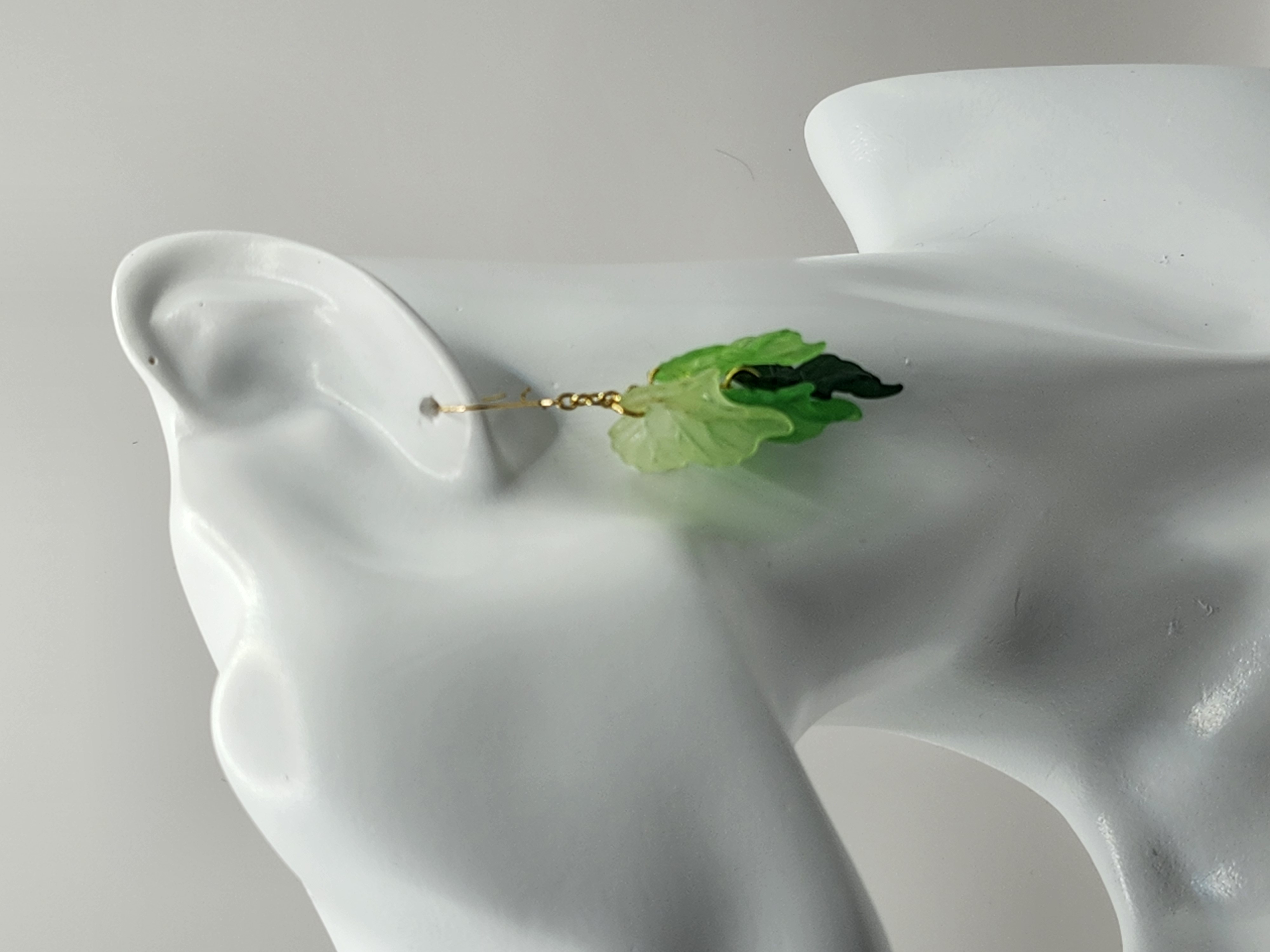 Handcrafted green leaf dangle earrings with gold chain accents. Lightweight, nature-inspired hypoallergenic jewelry