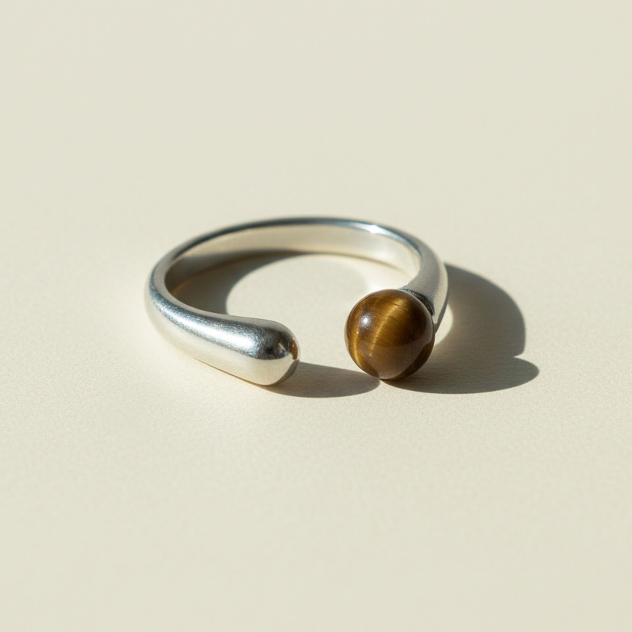 Silver open ring with tiger eye stone